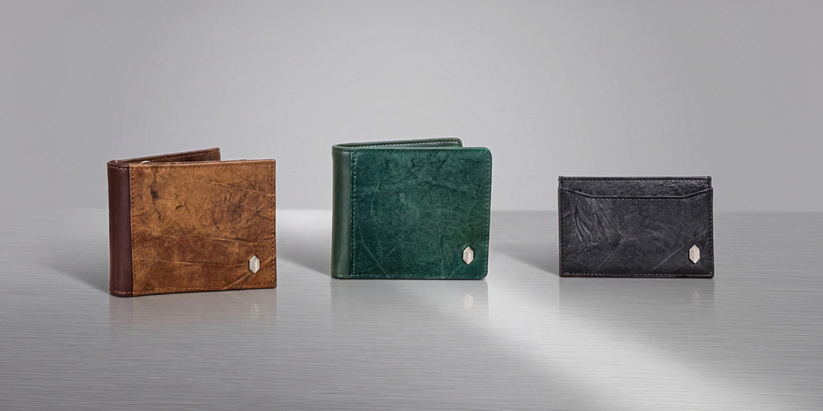 THAMON Oliver Vegan Wallet in Spice Brown, Vegan Coin Wallet in Forest Green and Vegan Cardholder in Black displayed side by side on a silver surface.