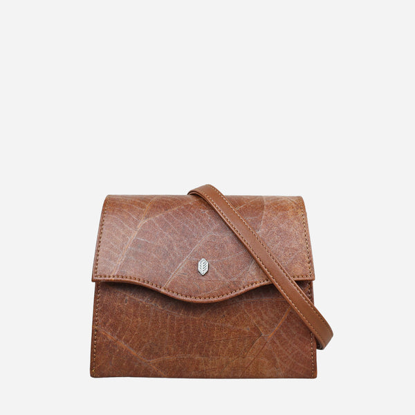 Front view of the Thamon Spice Brown Leaves Box Bag, featuring a leaf-embossed exterior in rich brown tones with a natural pattern, complemented by a brown tan strap and the signature Thamon silver logo on the flap.