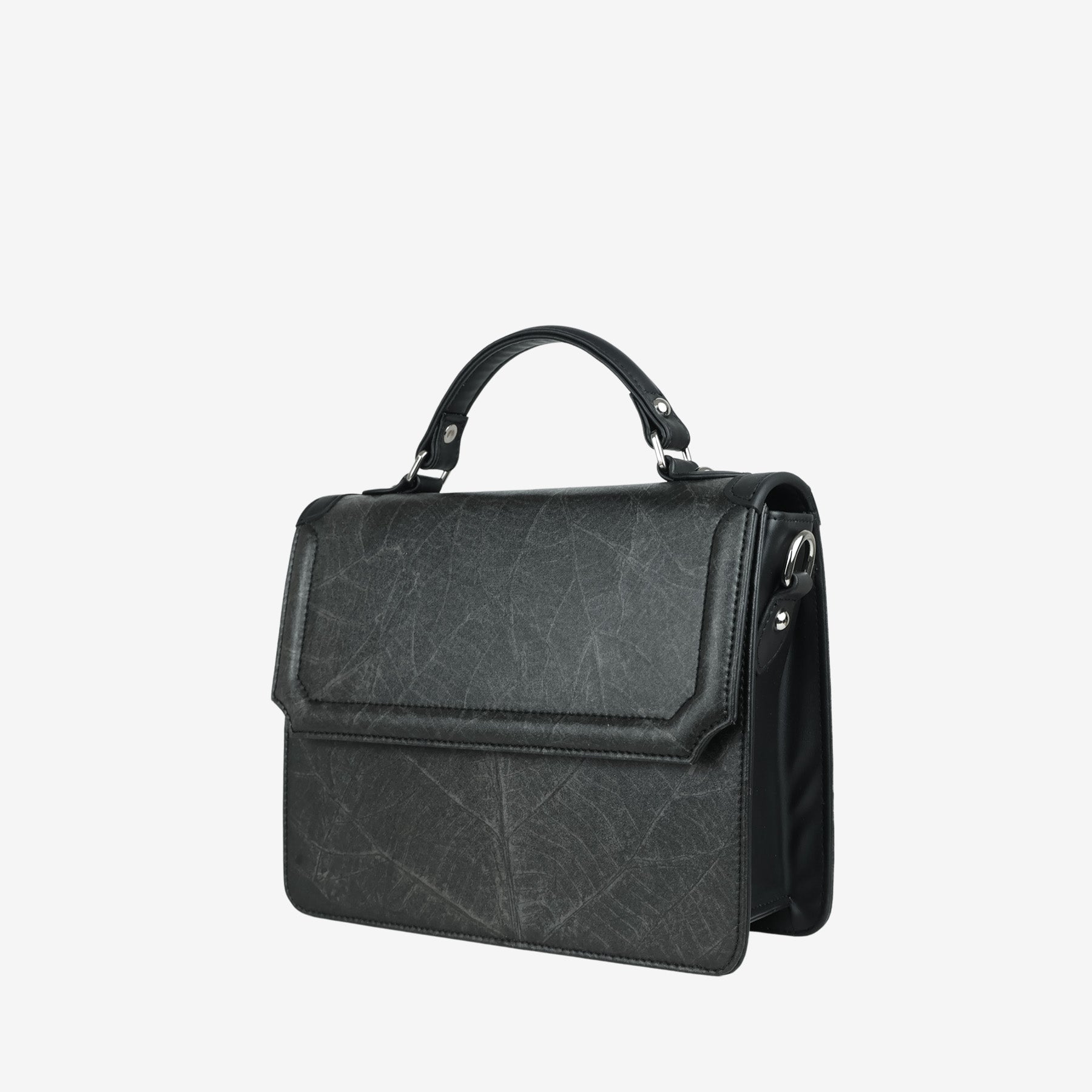 Side view of Camden crossbody bag in black Leaftex with top handle and flap design featuring natural leaf texture