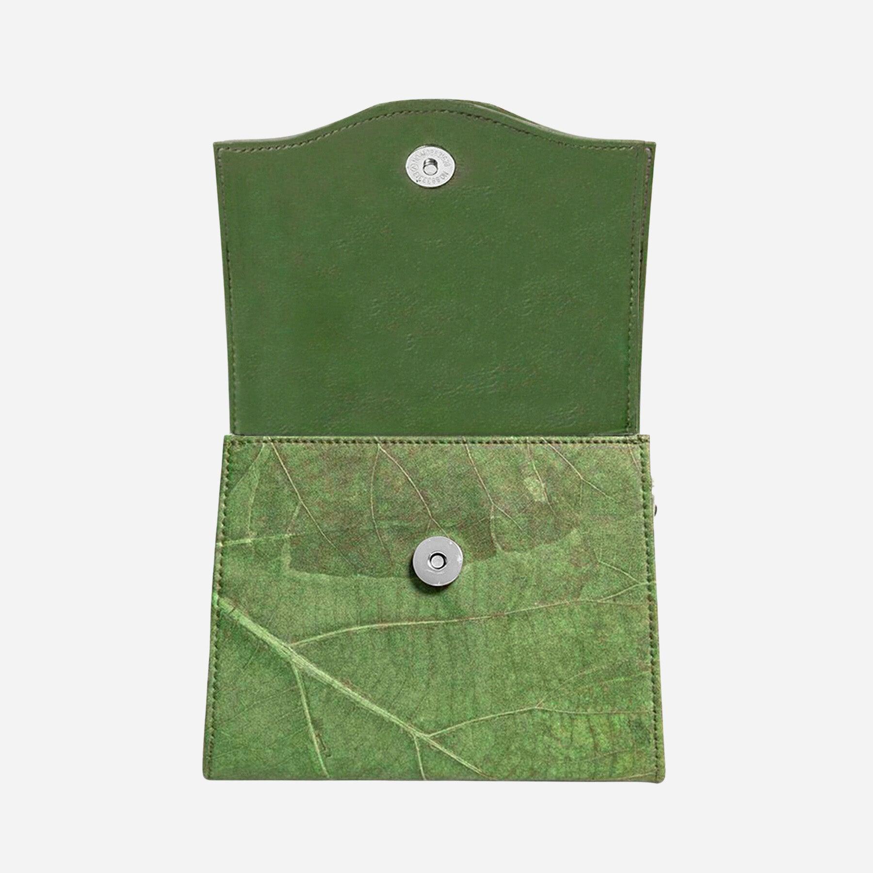 Open view of the Thamon Forest Green Leaf Leather Box Bag, displaying the natural leaf vein texture on the exterior flap and a smooth dark green interior with a secure metallic snap button