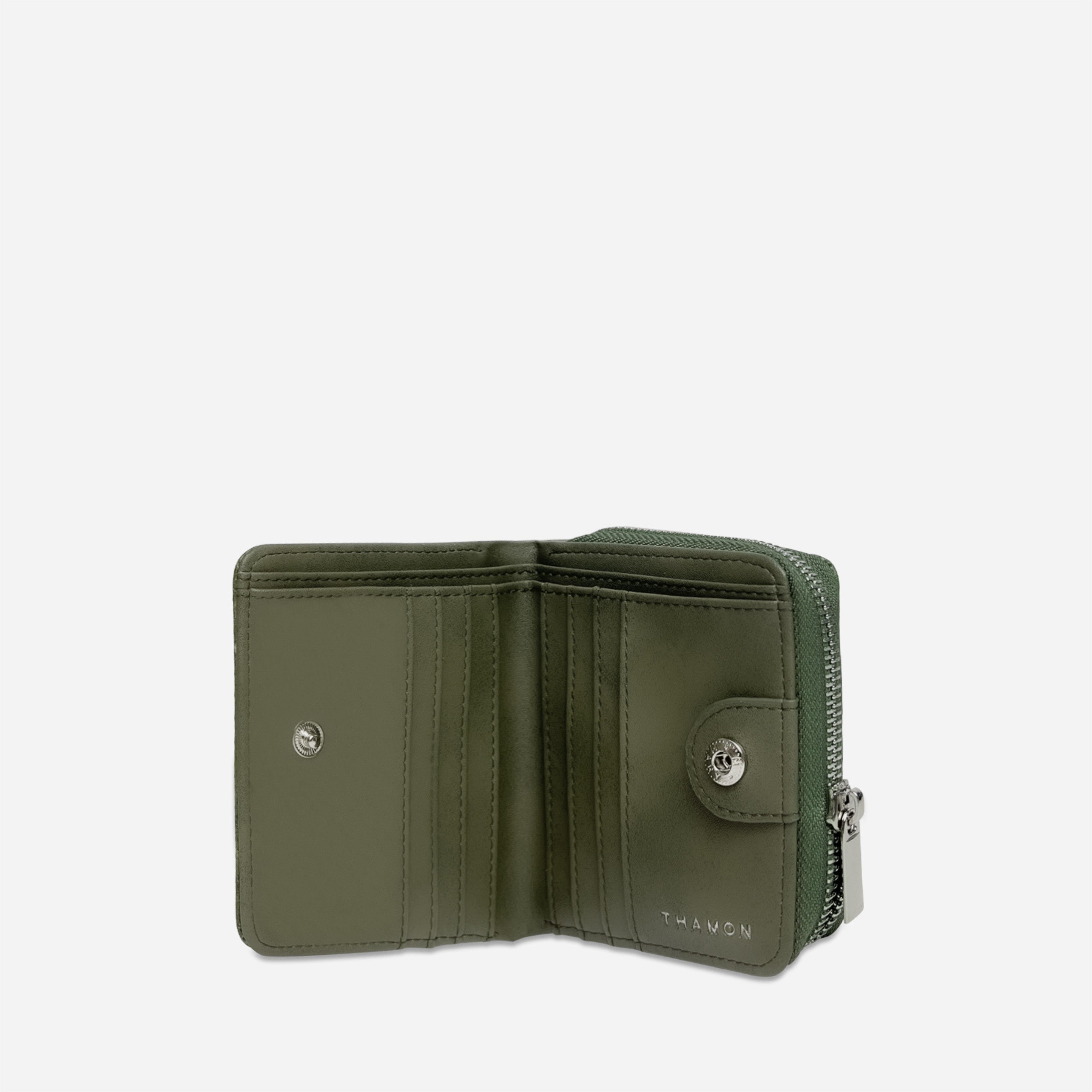 Open view of a Thamon forest green leaf leather compact zip-around wallet, showing two cash sections and card slots, with embossed branding.