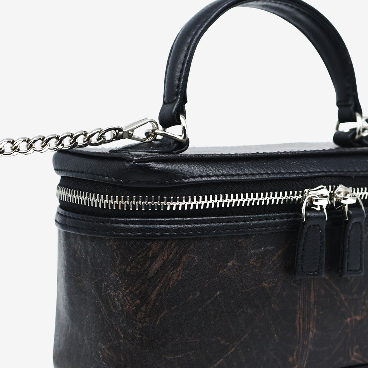 Close-up detail of Thamon Vanity Crossbody Bag in black Leaftex with silver hardware.
