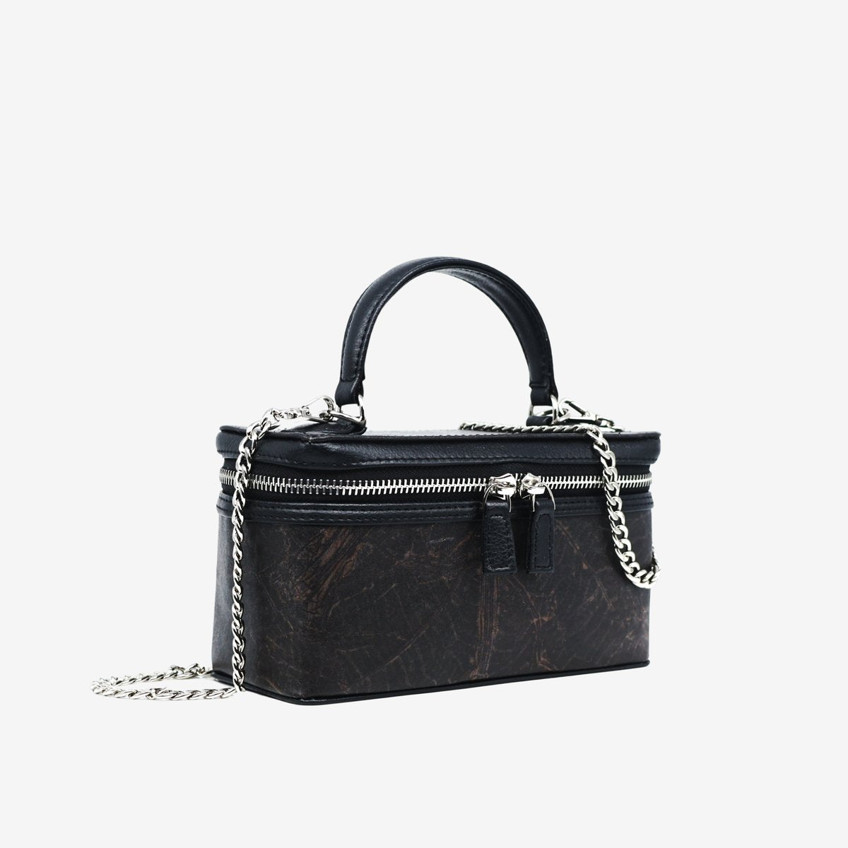 Side view of Thamon Vanity Crossbody Bag in black Leaftex with silver hardware.