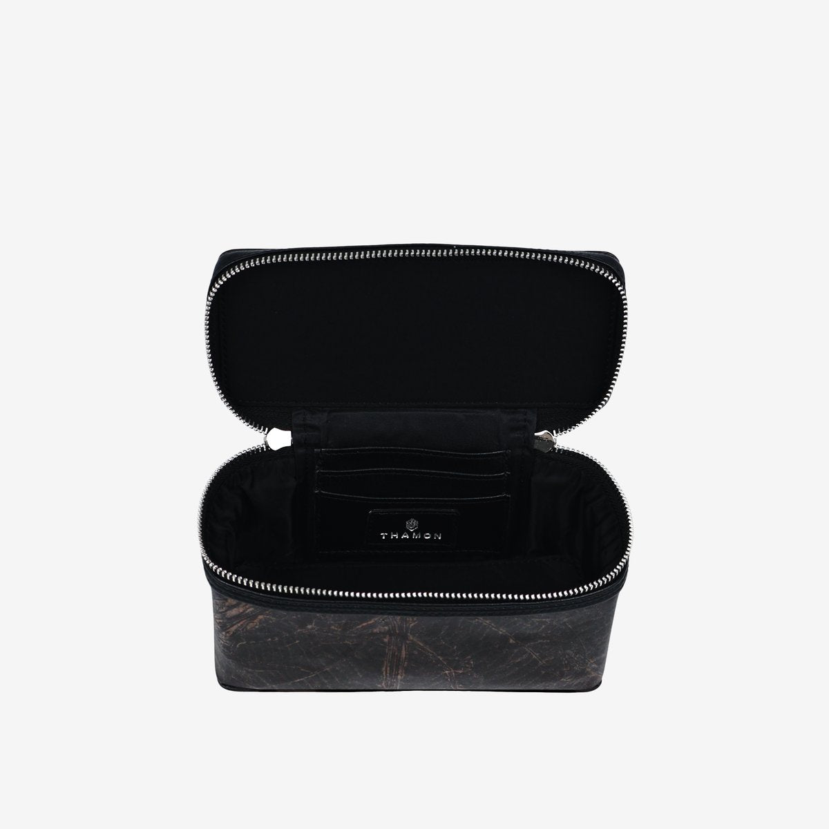 Top view of Thamon Vanity Crossbody Bag in black Leaftex with silver hardware.