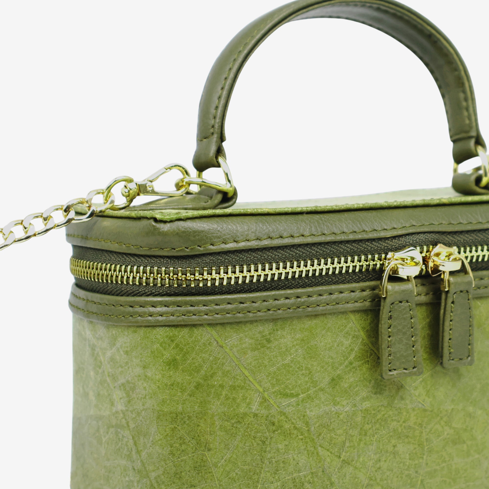 Close-up detail of Thamon Vanity Crossbody Bag in olive green Leaftex with gold hardware.
