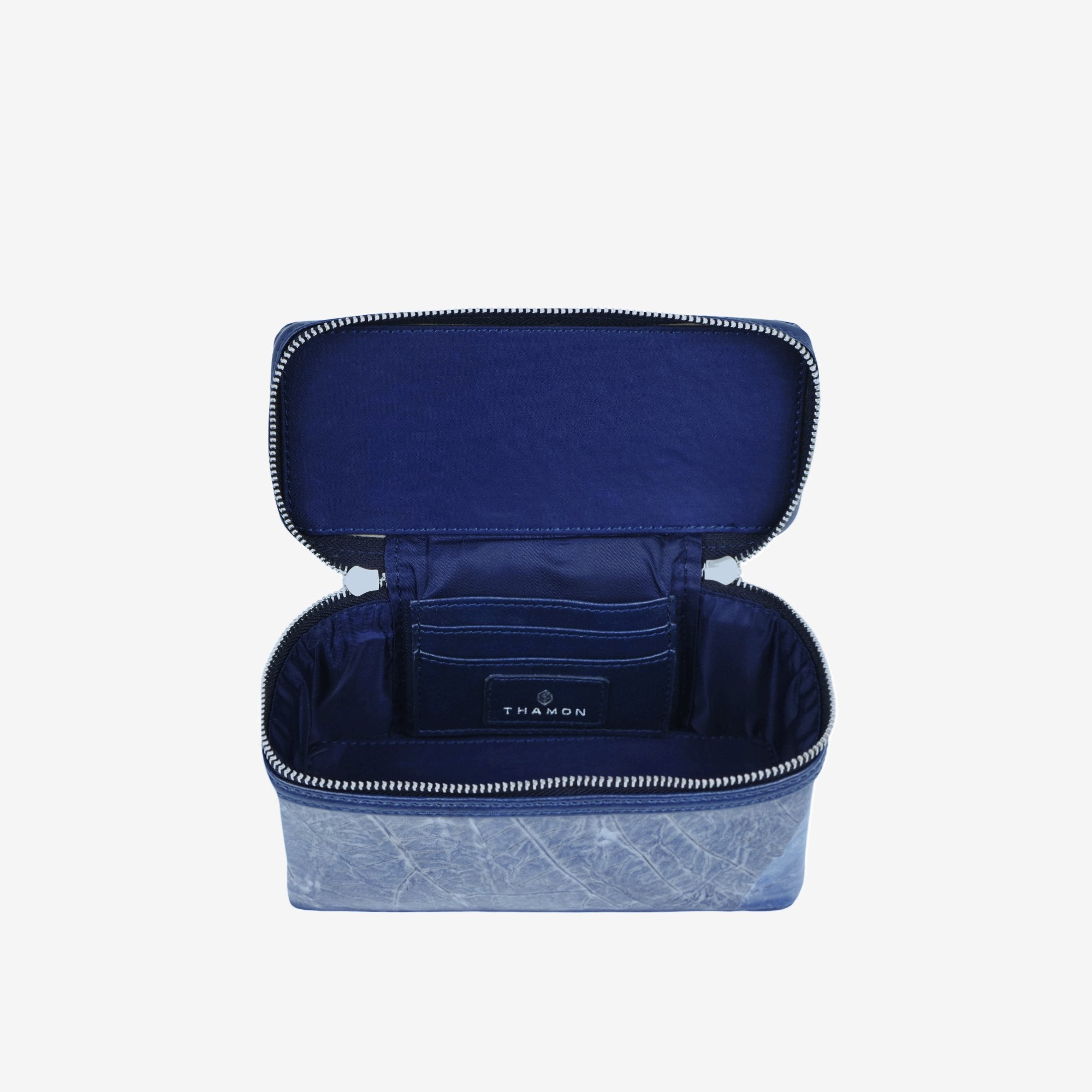 Top view of Thamon Vanity Crossbody Bag in sapphire Leaftex with silver hardware.