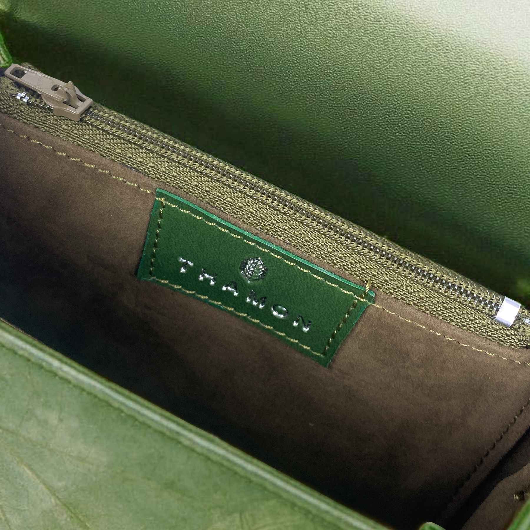 Interior view of Box bag in olive green showing spacious main compartment and inner lining