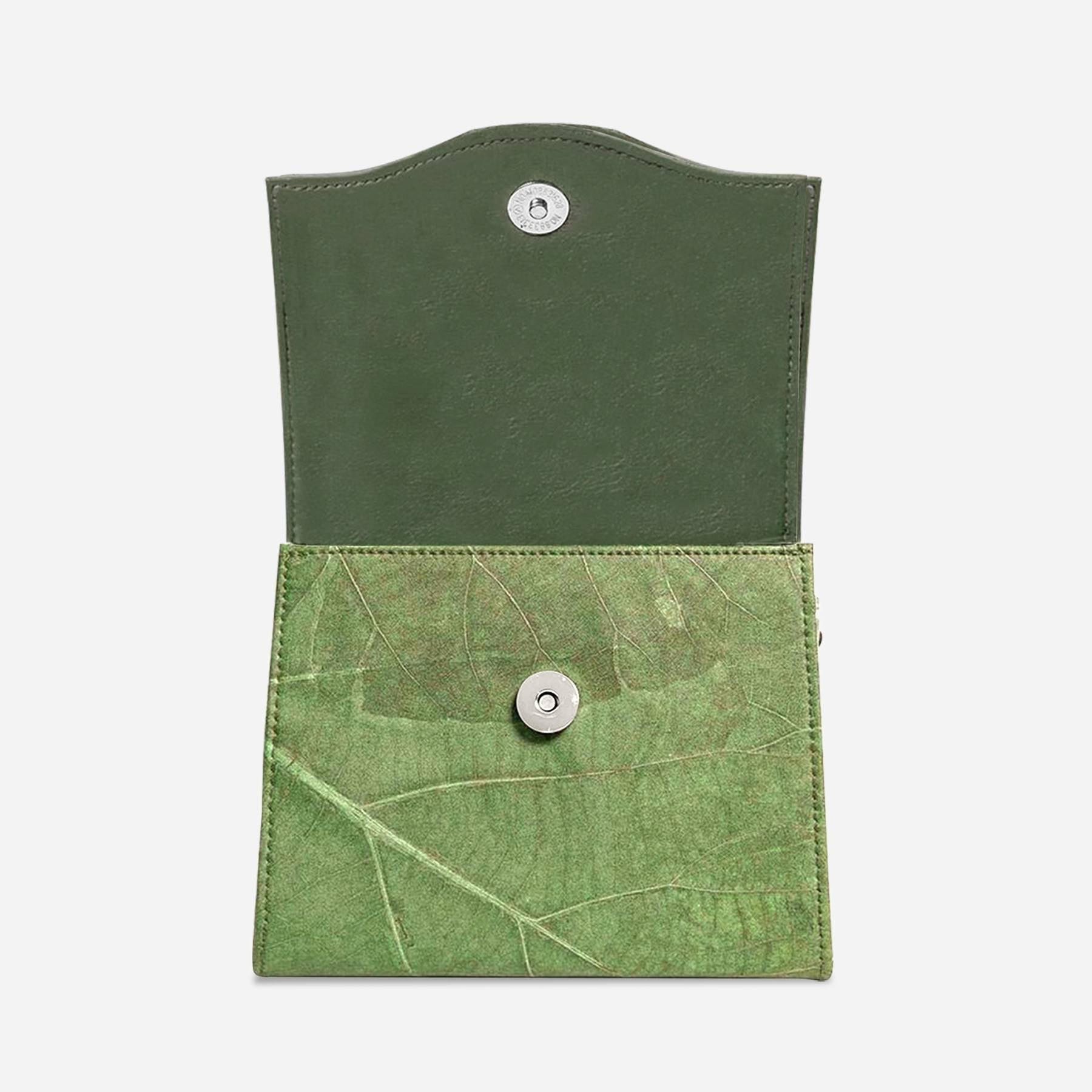 Top view of open Box bag in olive green leaf leather showcasing the inner flap and front latch
