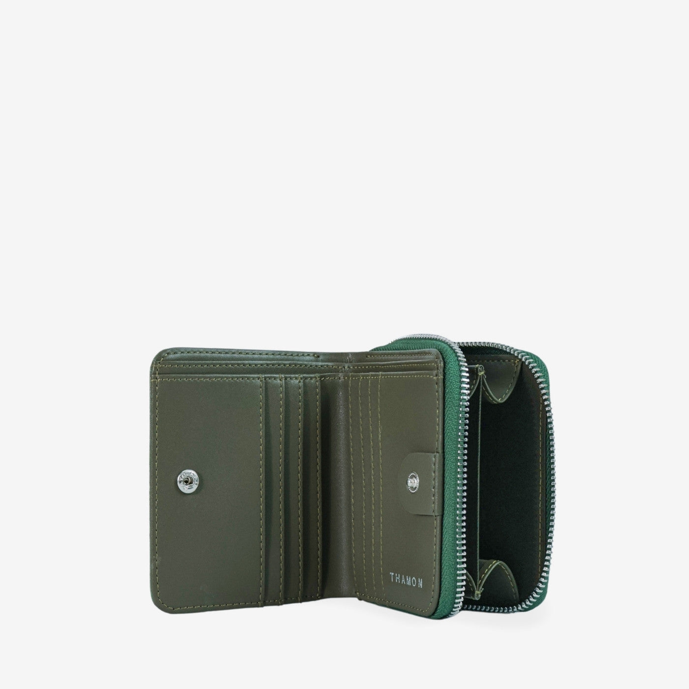 Detail of open compact zip wallet in dark olive green made from leaf leather