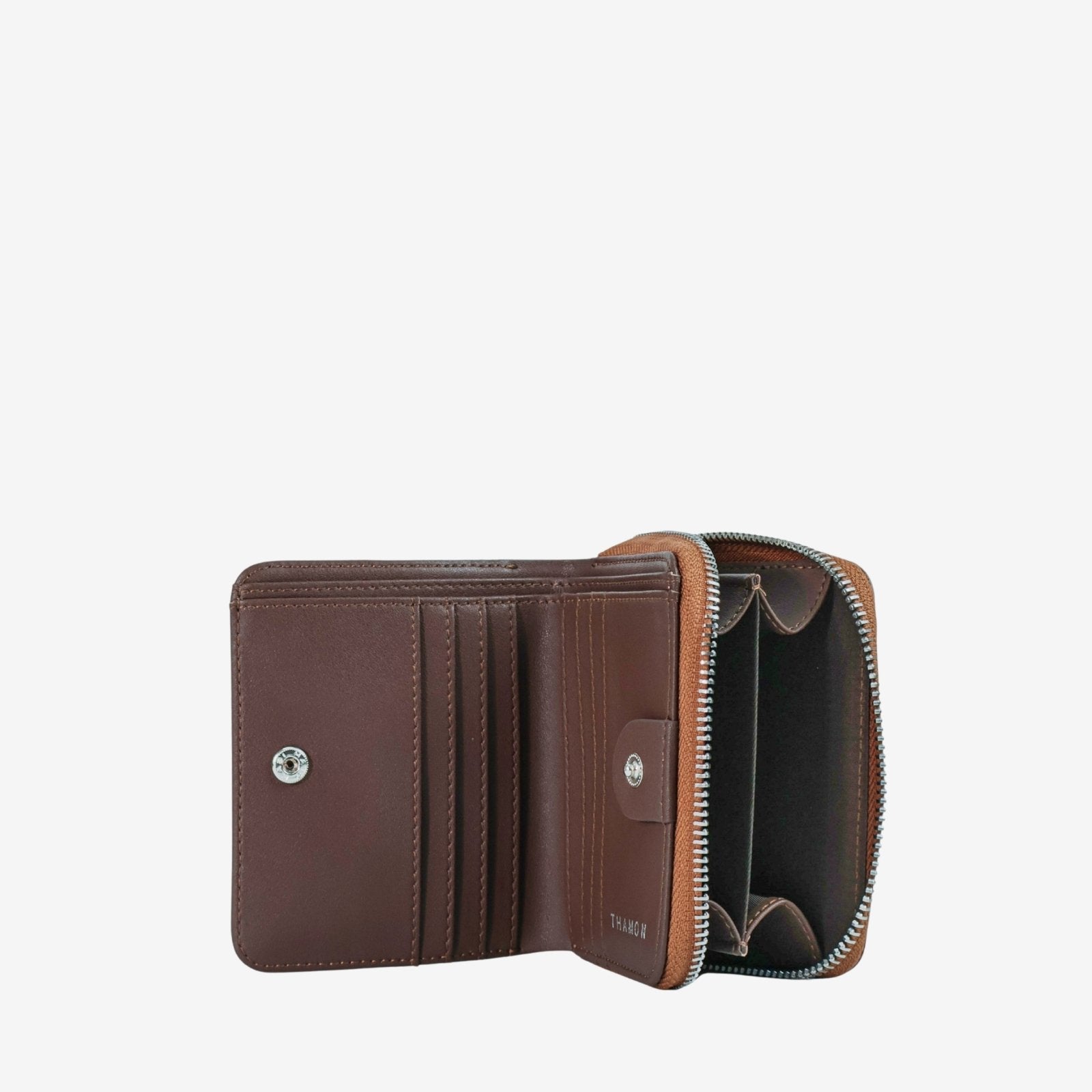 Detail of open compact zip wallet in spice brown made from leaf leather
