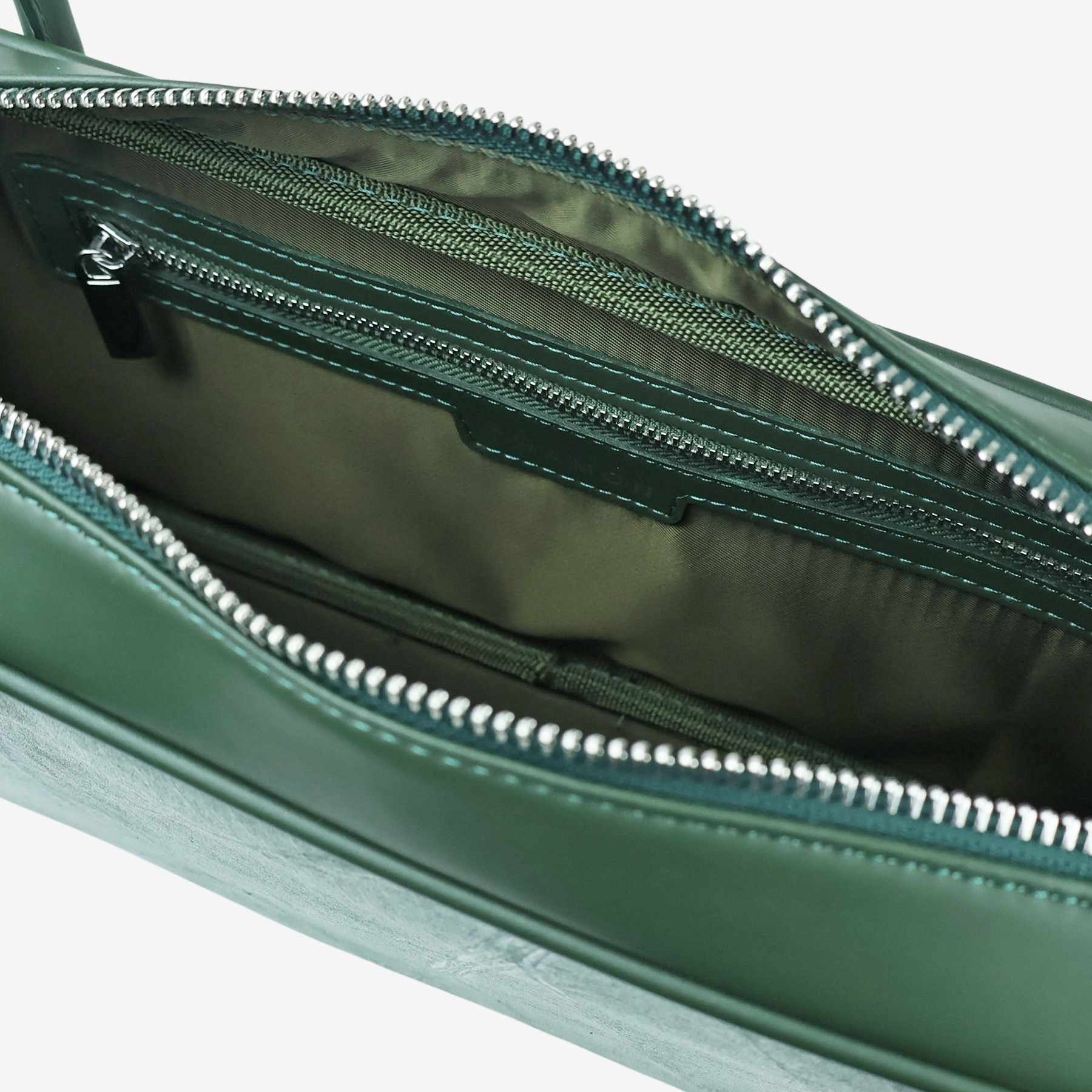 Interior view showing olive green lining of Craugette bag in forest green leaf leather