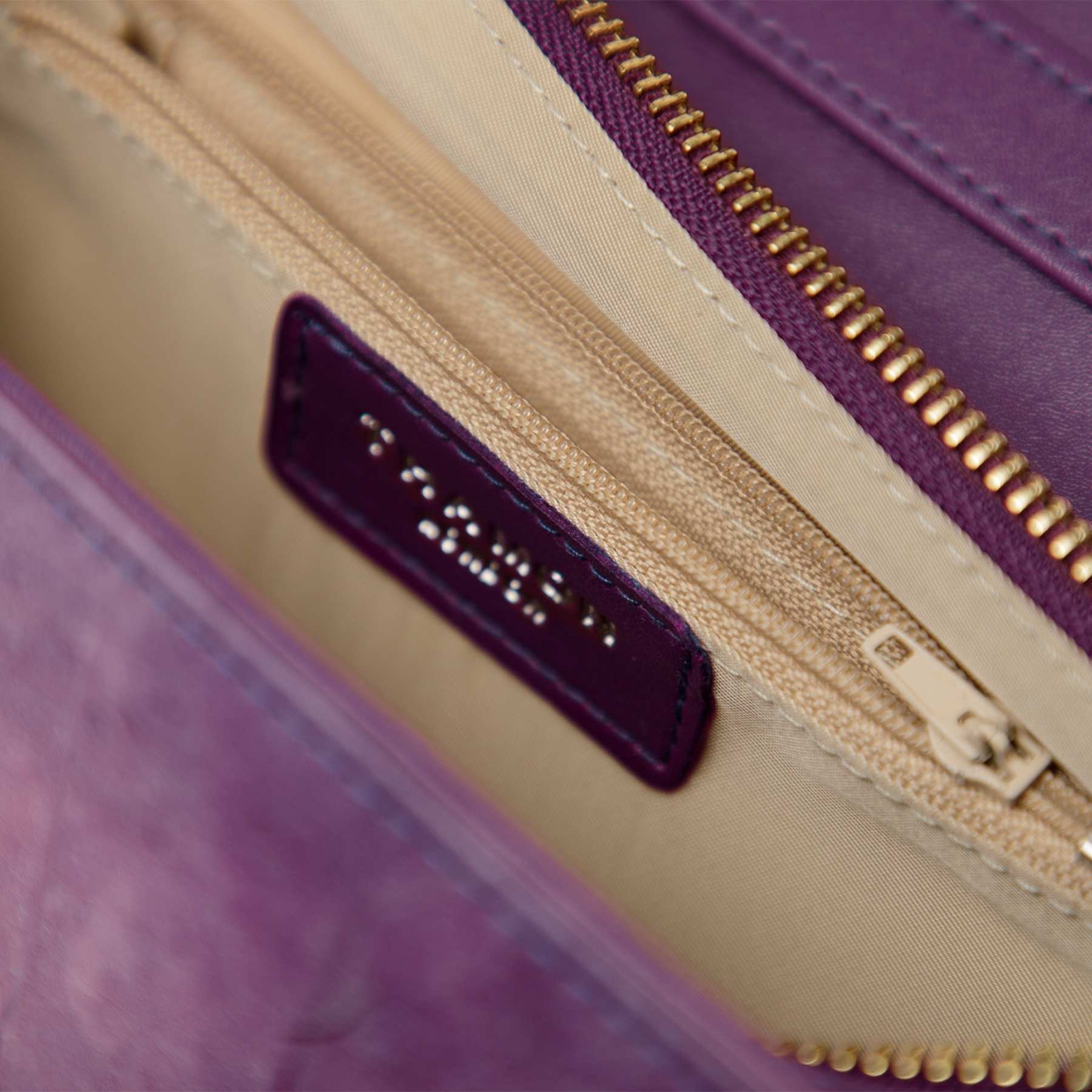 Close-up of interior compartments in Ellie handle bag lavender leaf leather