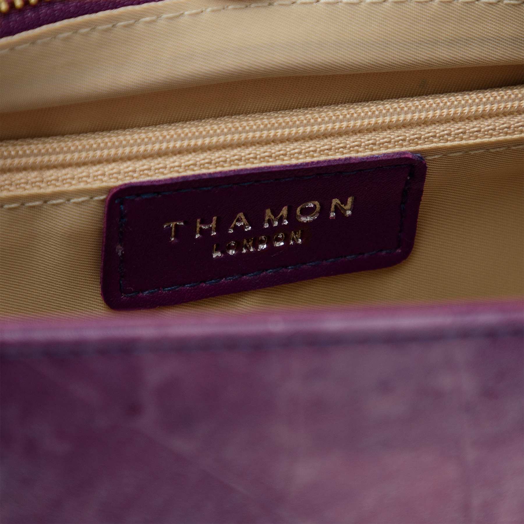 Interior detail of Thamon logo in Ellie handle bag lavender leaf leather