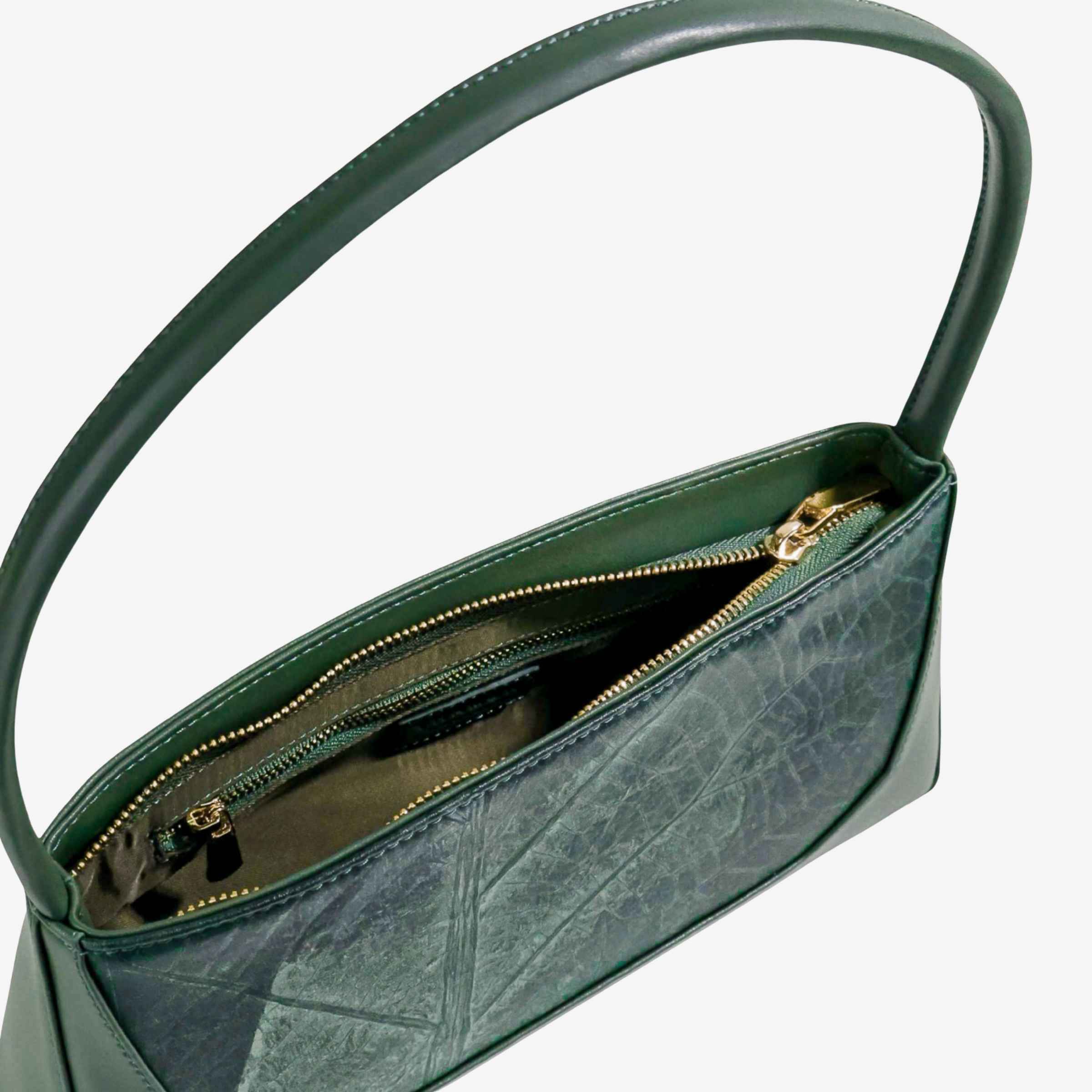 Interior view of forest green IVES bag displaying the spacious main compartment and lining