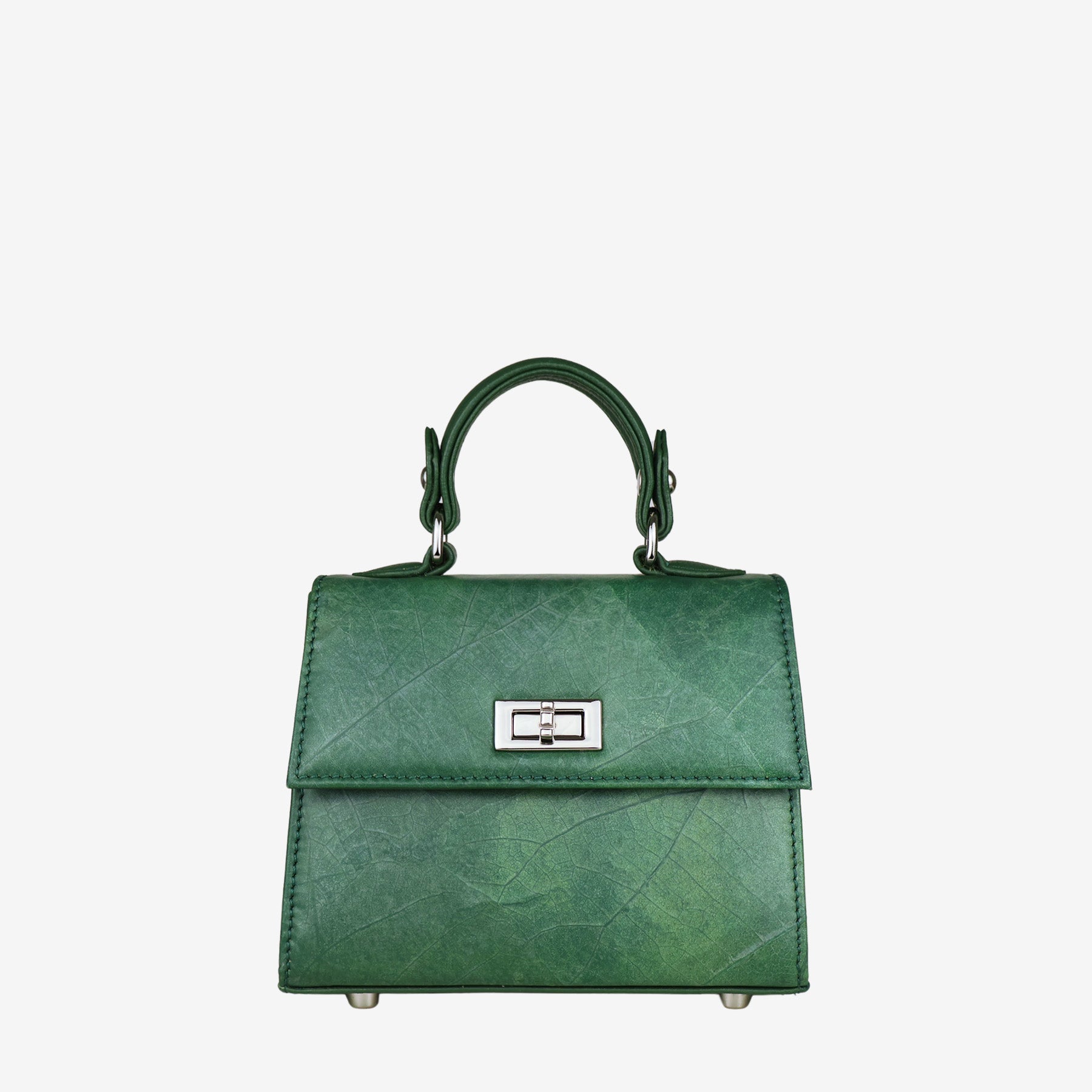 Front view of a structured, deep green women's handbag with a subtle leaf-like texture. The bag features a shiny silver-tone twist-lock closure on the front flap and a single top handle connected by matching hardware. The bag's body and flap are made of the textured material, while the sides are smooth. Four silver-tone metal feet are visible on the bottom.