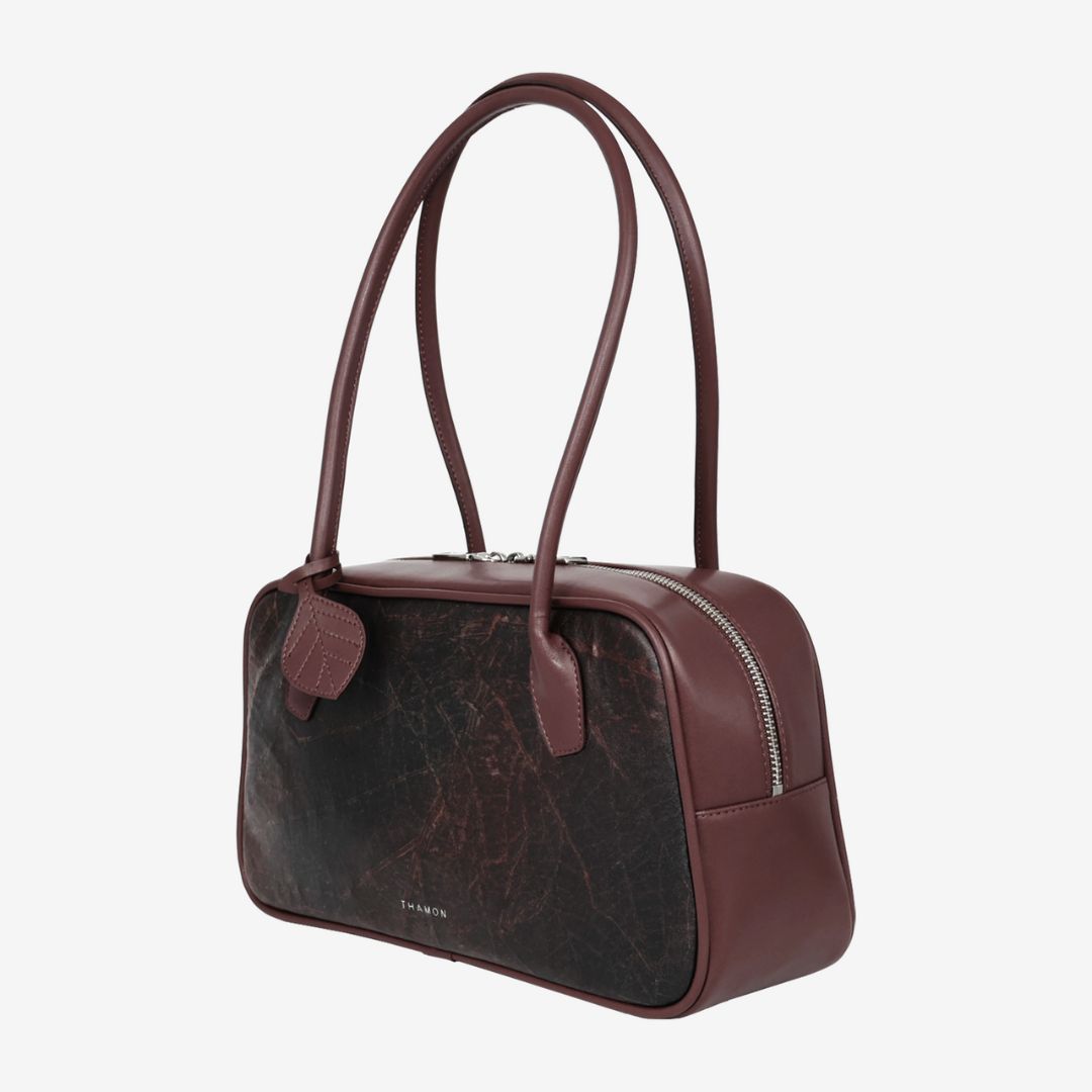 Side profile of Thamon Boston Shoulder Bag in rustic brown with tonal handles and stitching.