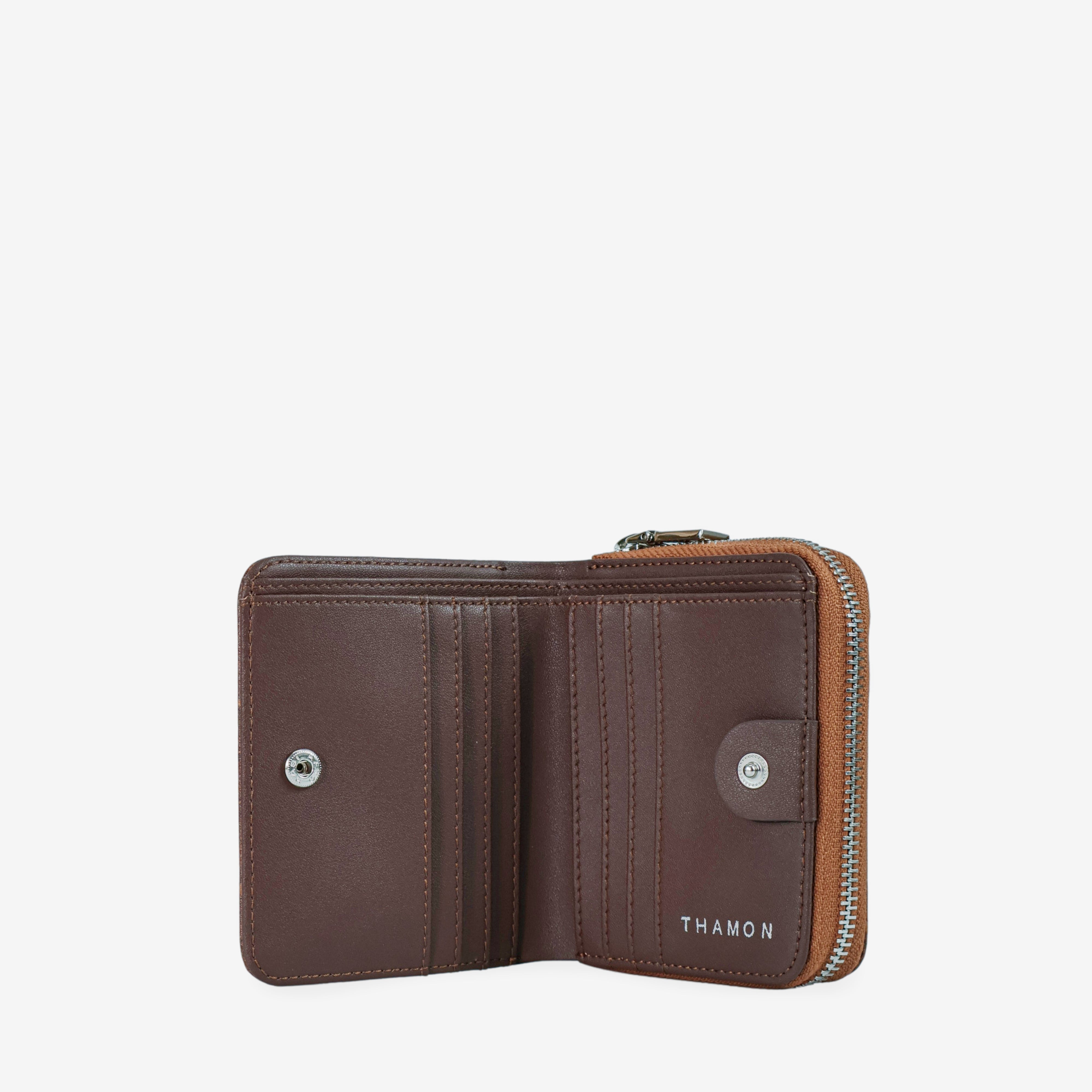 Open Thamon spice brown leaf leather wallet, revealing two cash sections, card slots, and embossed branding.
