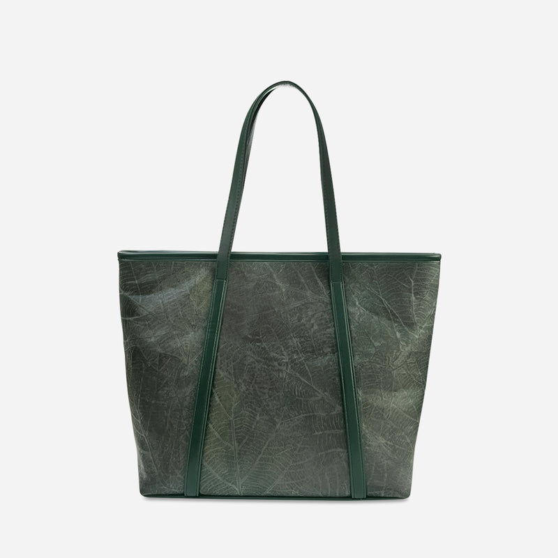 Front view of the Thamon forest green Alma tote bag, crafted from sustainable leaf leather with a unique foliage imprint, featuring strong, slender shoulder straps for comfortable carrying.