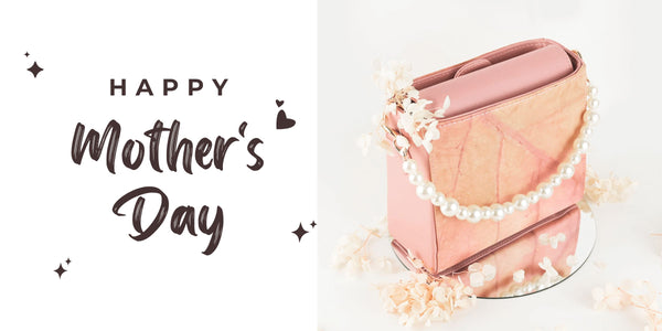 Thamon Mother's Day Pearl Vegan Crossbody Bag in Blossom pink with faux pearl strap and eco-friendly leaf leather, surrounded by delicate white flowers on a reflective surface.