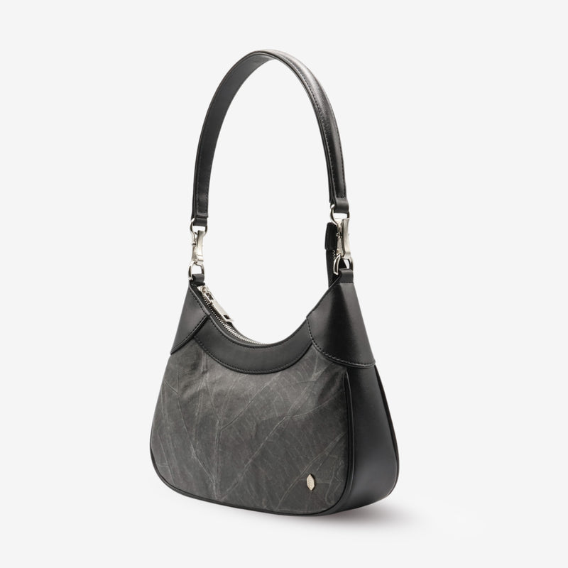 Side view of the Kara Vegan Shoulder Bag in Black showcasing the elegant design and structured form