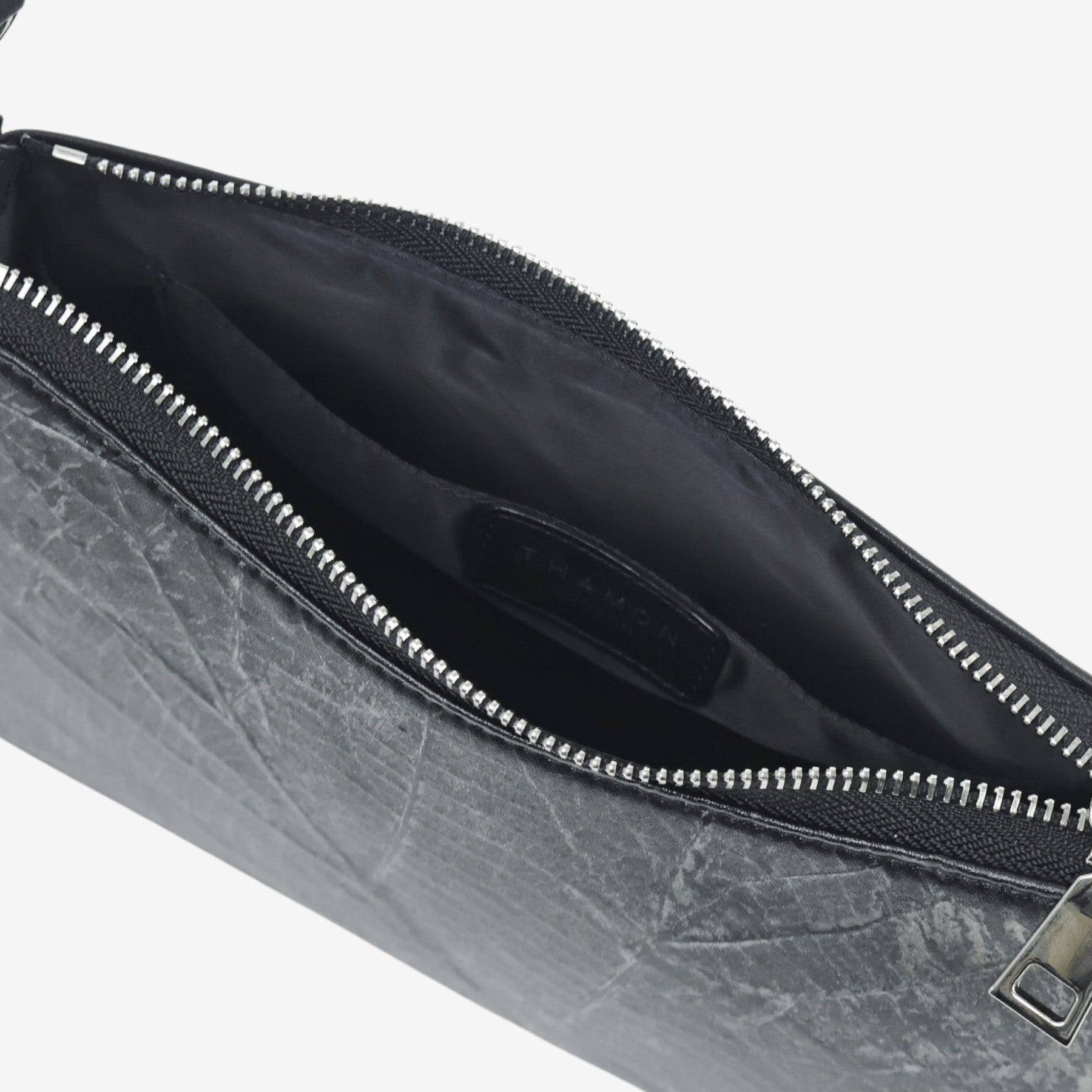 Interior view of the Black Maki bag with the THAMON logo and eco-friendly lining