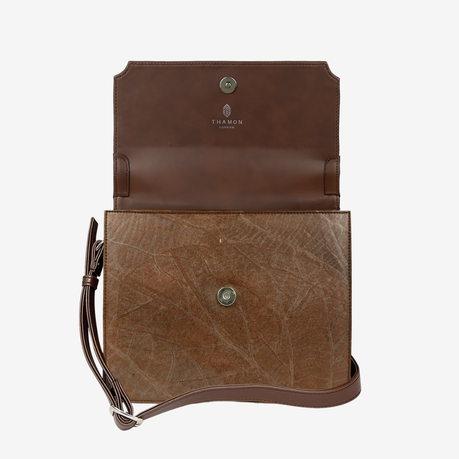 Front view of Camden crossbody bag in walnut brown Leaftex, featuring flap closure, top handle, and natural leaf pattern texture