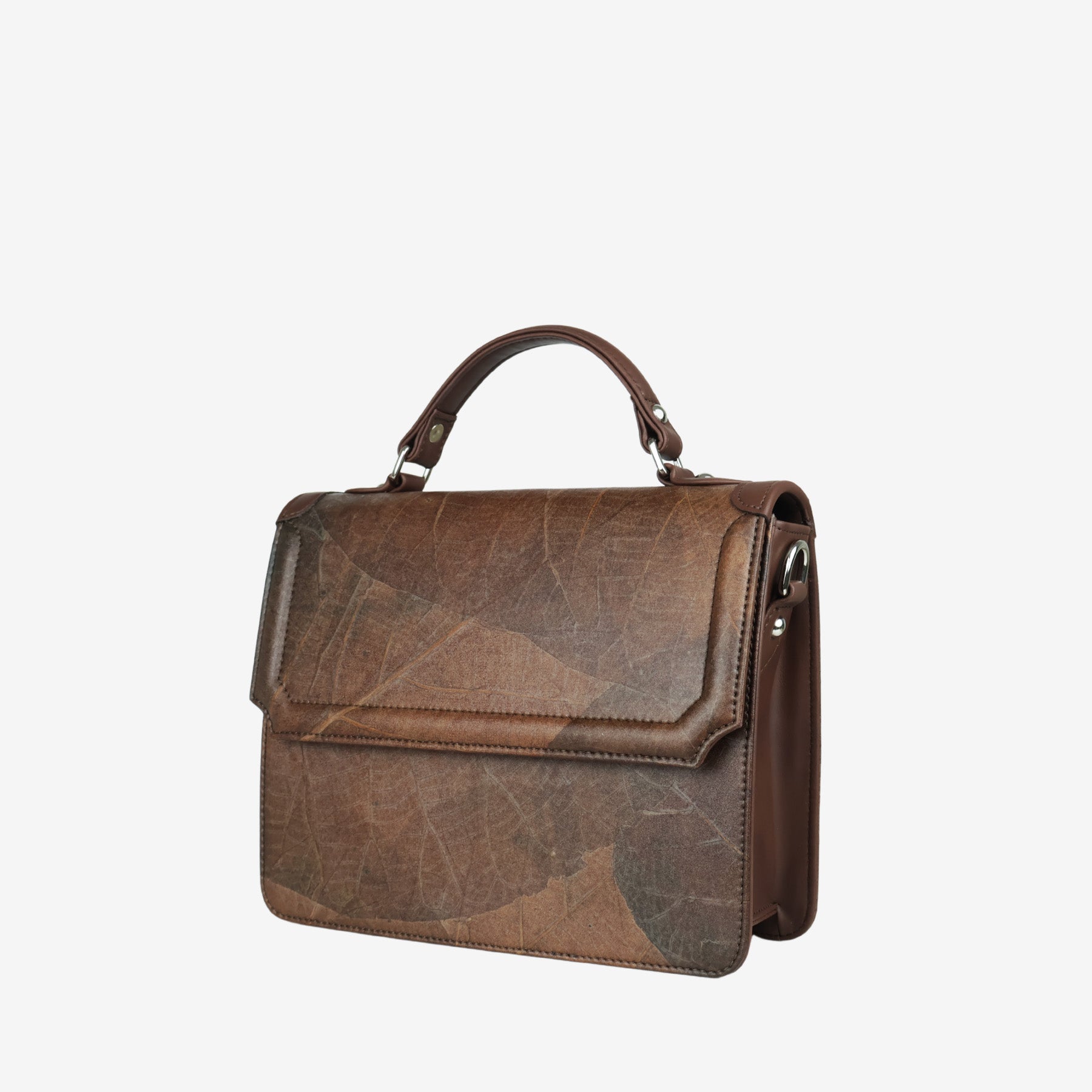 Side view of Camden crossbody bag in walnut brown Leaftex™, featuring top handle and flap design with natural leaf texture