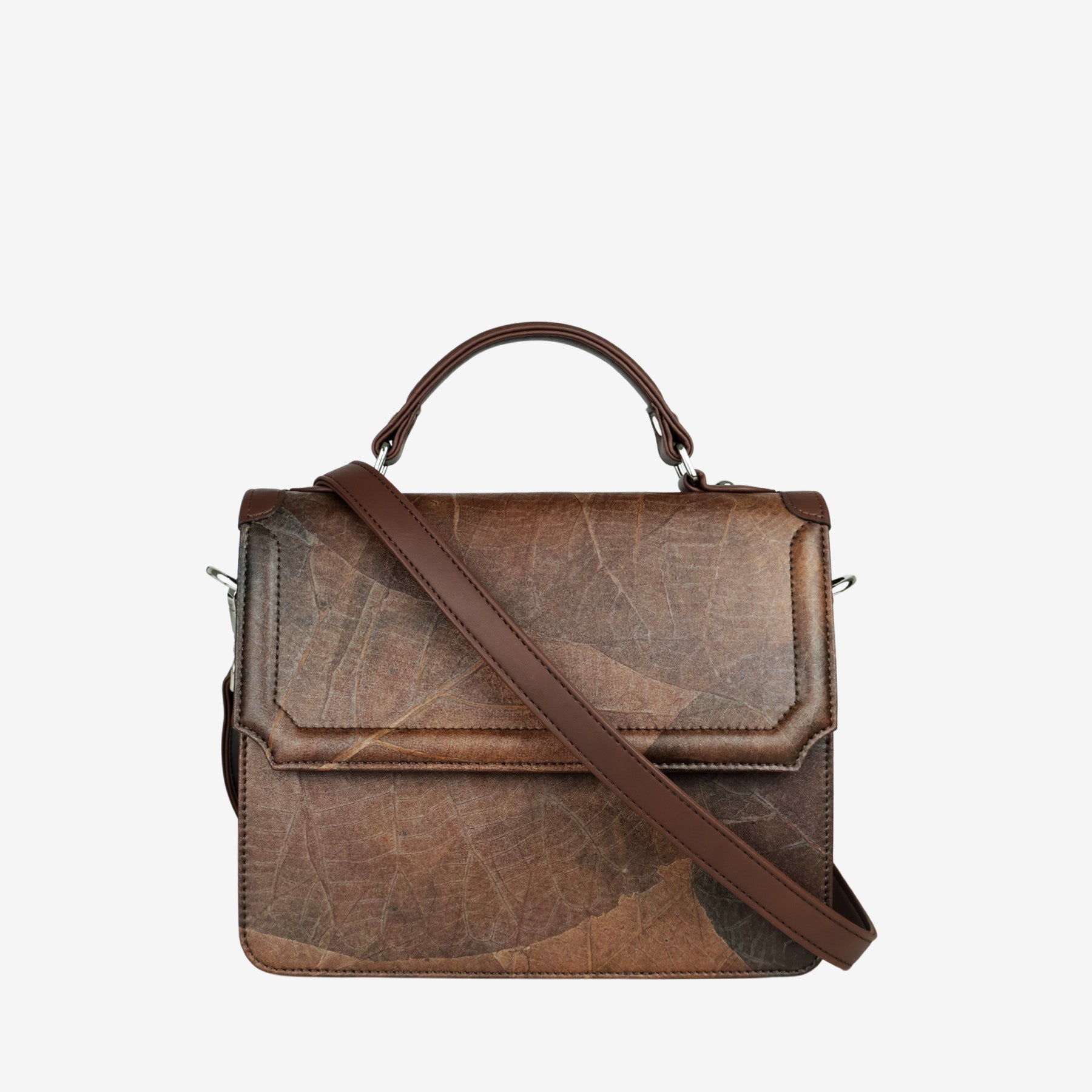 Camden crossbody bag in walnut brown Leaftex with adjustable strap draped across front and top handle detail