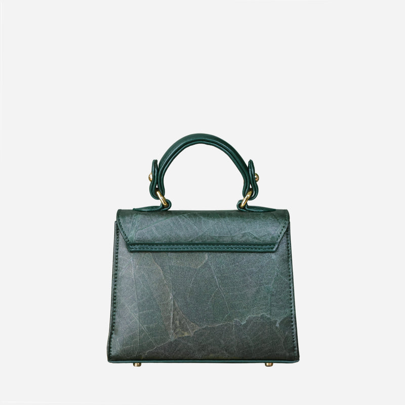 "Back view of the Thamon Kylie mini handbag in a rich forest green shade, showcasing the detailed leaf leather texture and the bag's clean lines and sturdy top handle, set on a neutral background for clarity