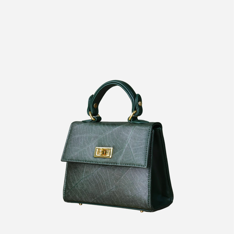 Side view of Thamon's 'Kylie' mini handbag in forest green, crafted from sustainable leaf leather, featuring a classic structured design with a gold-tone twist lock and a sturdy top handle.