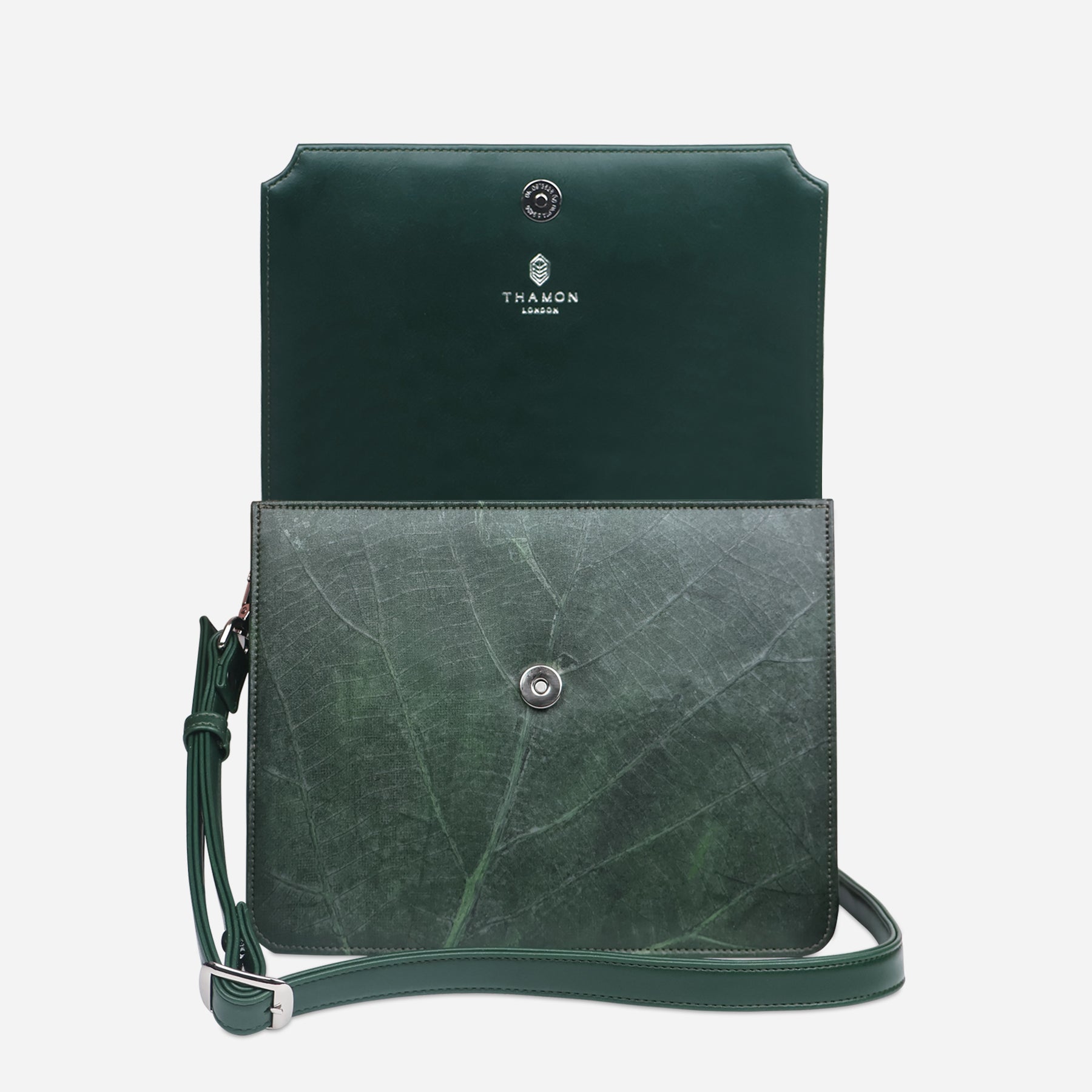 Front view of Camden bag in forest green Leaftex with flap open, showcasing magnetic closure and interior branding