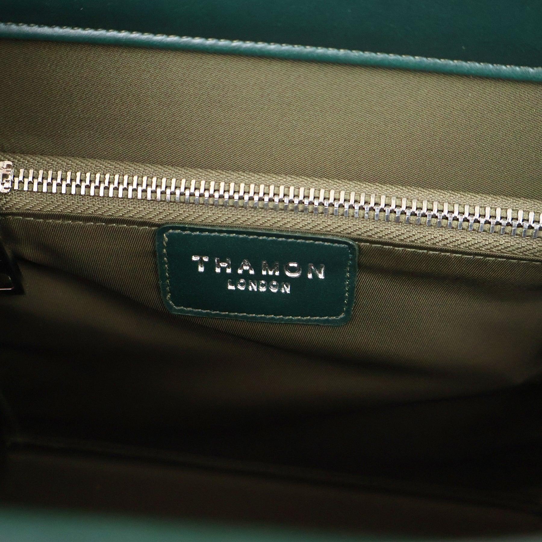Interior logo detail of the Forest Green Ingrid Bag by Thamon, featuring Leaftex (real leaf leather) and zippered lining.