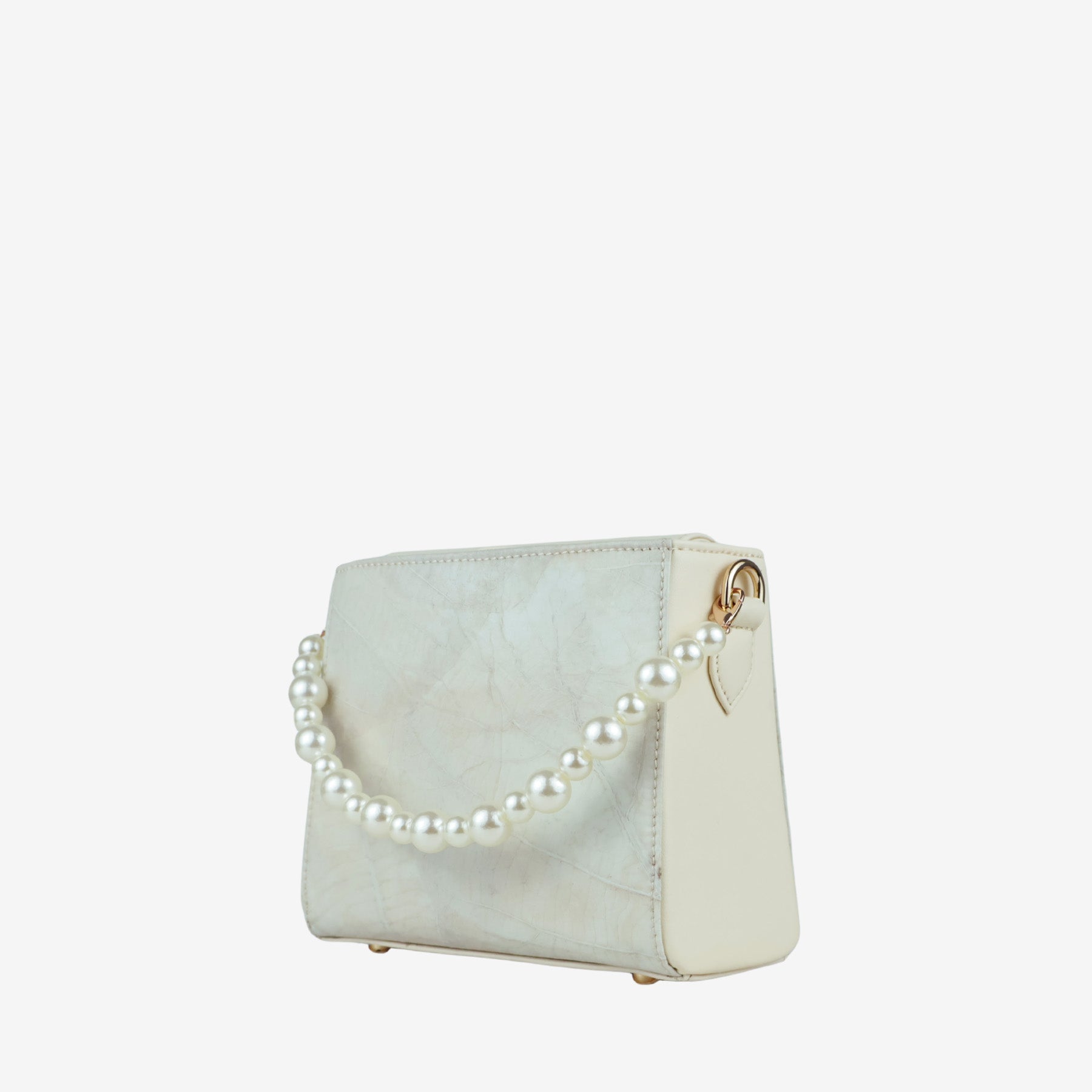 Thamon Pearl Ivory White bag made from leaf leather, featuring a string of round pearls as a top handle and a small blue dot detail. The bag is shown from a slight angle against a white background.