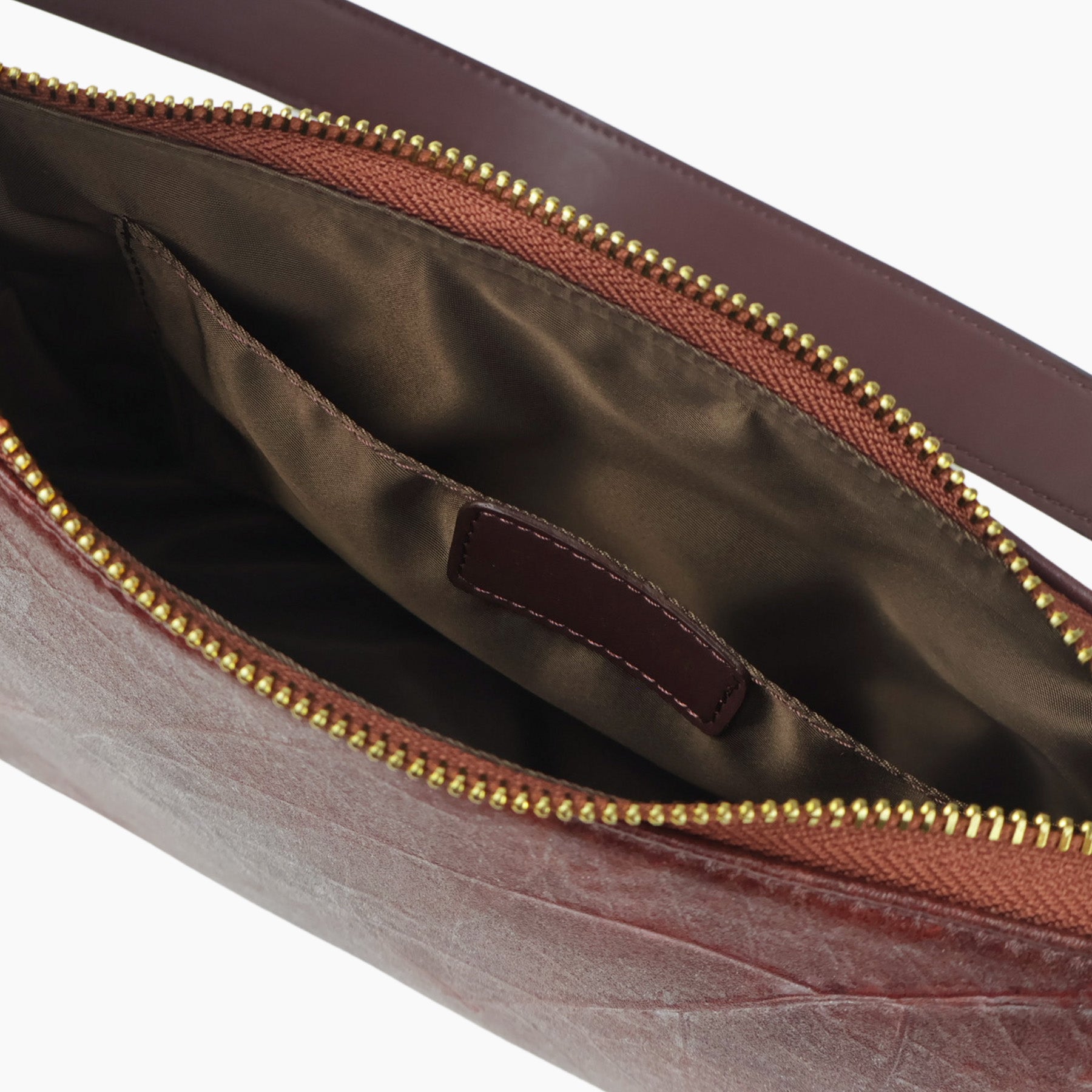 Interior view of Spice Brown Maki bag with brown lining and leather pocket
