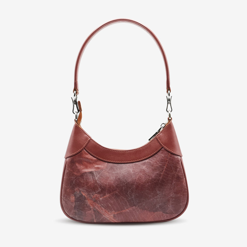 detachable crossbody strap and side profile.
Back view of Kara Vegan Shoulder Bag in Chestnut Brown by Thamon featuring its smooth, eco-friendly vegan leather.