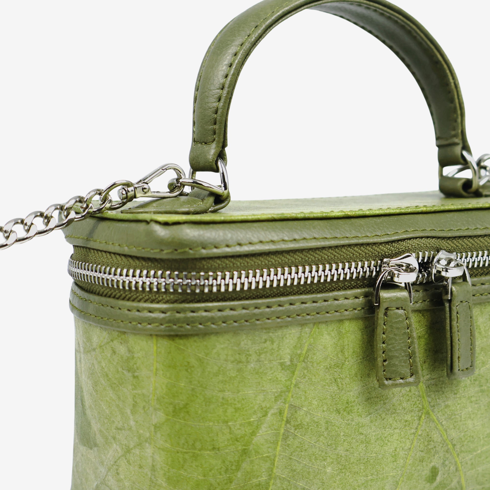 Close-up detail of Thamon Vanity Crossbody Bag in olive green Leaftex with silver hardware.