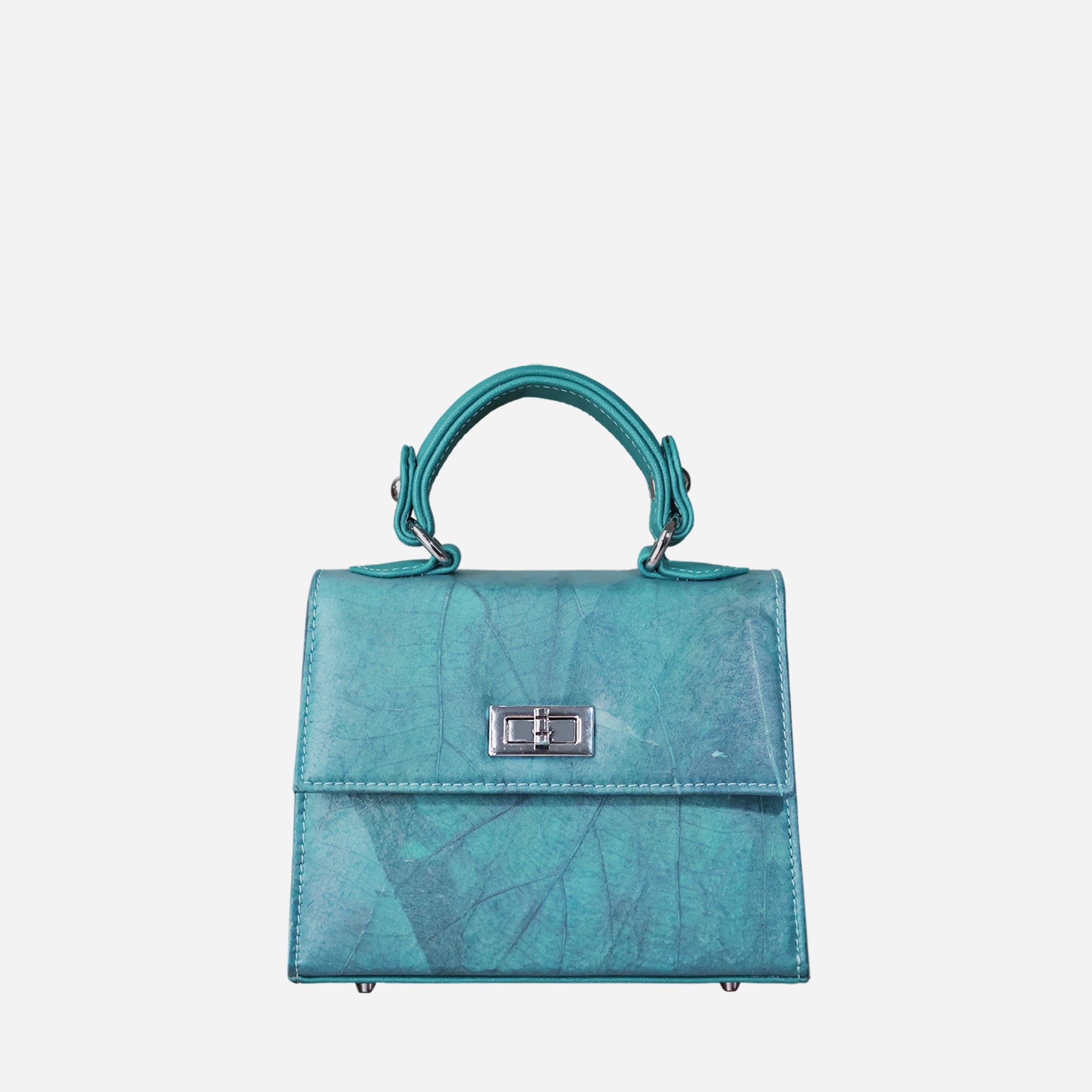 Front view of a structured, teal-colored women's handbag with a subtle leaf-like texture. The bag features a shiny silver-tone twist-lock closure on the front flap and a single top handle connected by matching hardware. The bag's body and flap are made of the textured material, while the sides are smooth. Four silver-tone metal feet are visible on the bottom.