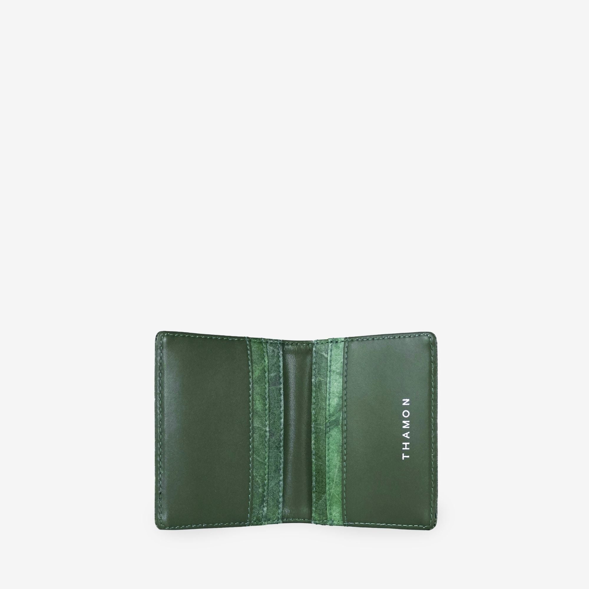 THAMON Bifold Cardholder in Forest Green made with real-leaf Leaftex and vegan microfiber, shown open with interior card slots.