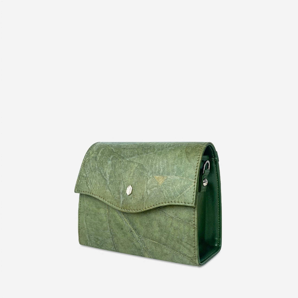 Side view of the BOX crossbody bag in Olive Green Leaftex, showing its structured shape, silver hardware and natural leaf texture.