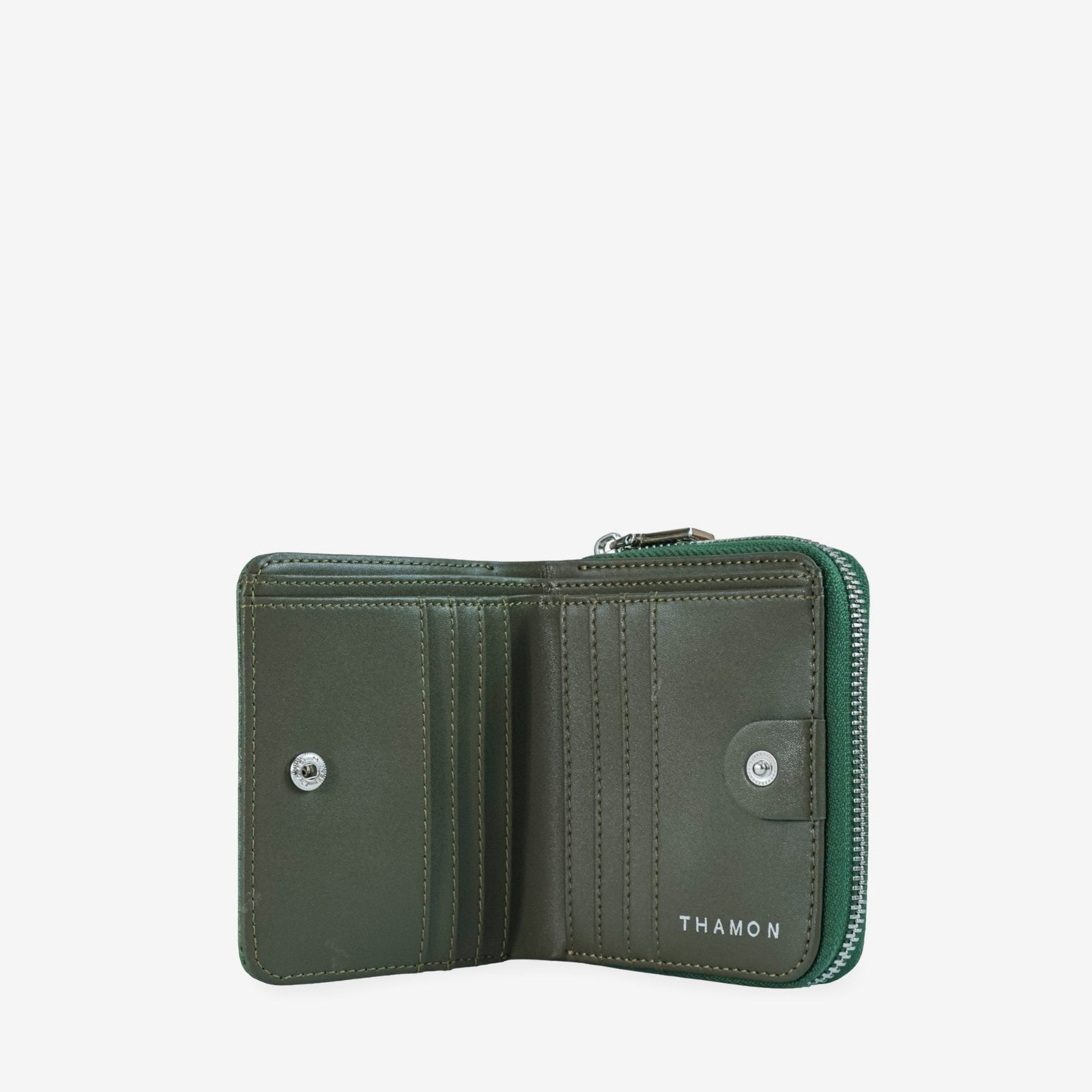 Interior of compact zip wallet in dark olive green made from leaf leather