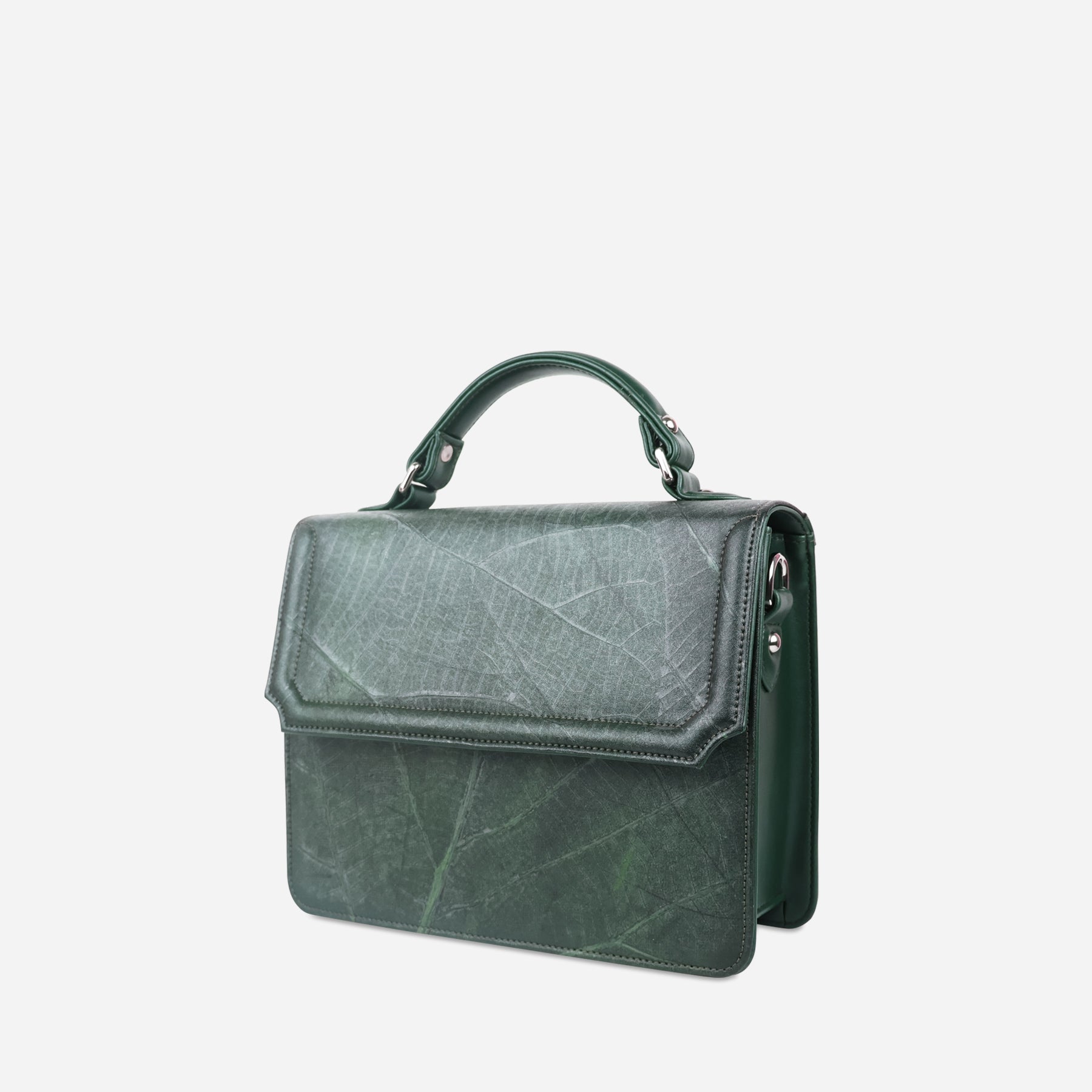 Side view of Camden crossbody bag in forest green Leaftex with top handle, flap closure, and visible leaf vein pattern