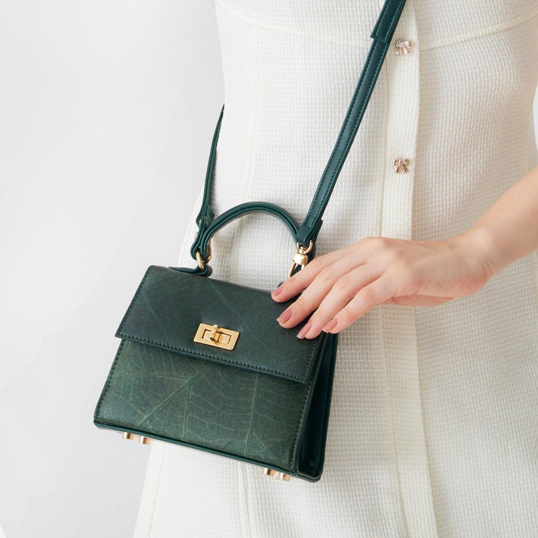 Front view of Kylie Mini Bag in Forest Green Leaf Leather by Thamon, emphasizing the detailed leaf pattern and gold twist-lock closure.