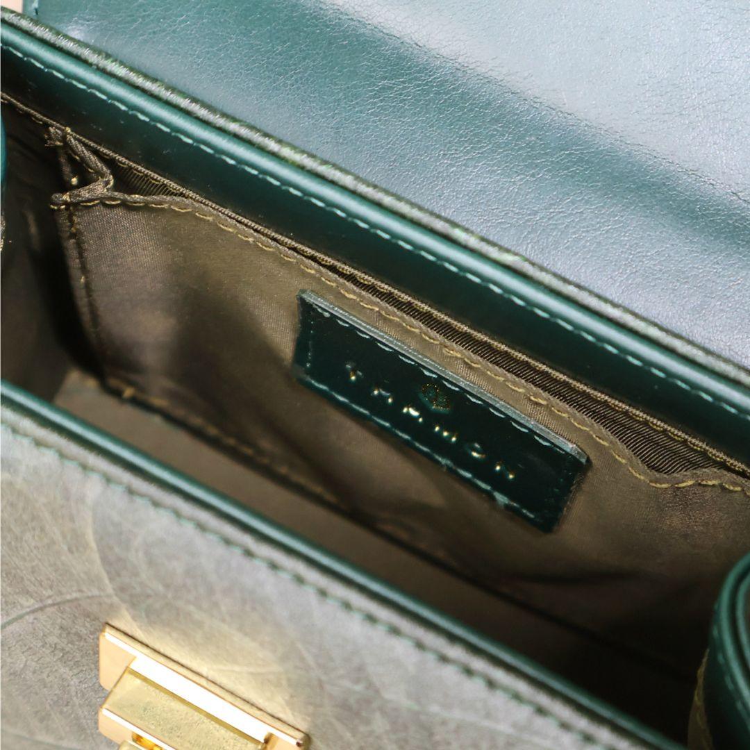 Interior view of Kylie Mini Bag in Forest Green Leaf Leather by Thamon, showcasing the spacious compartment and open pocket.