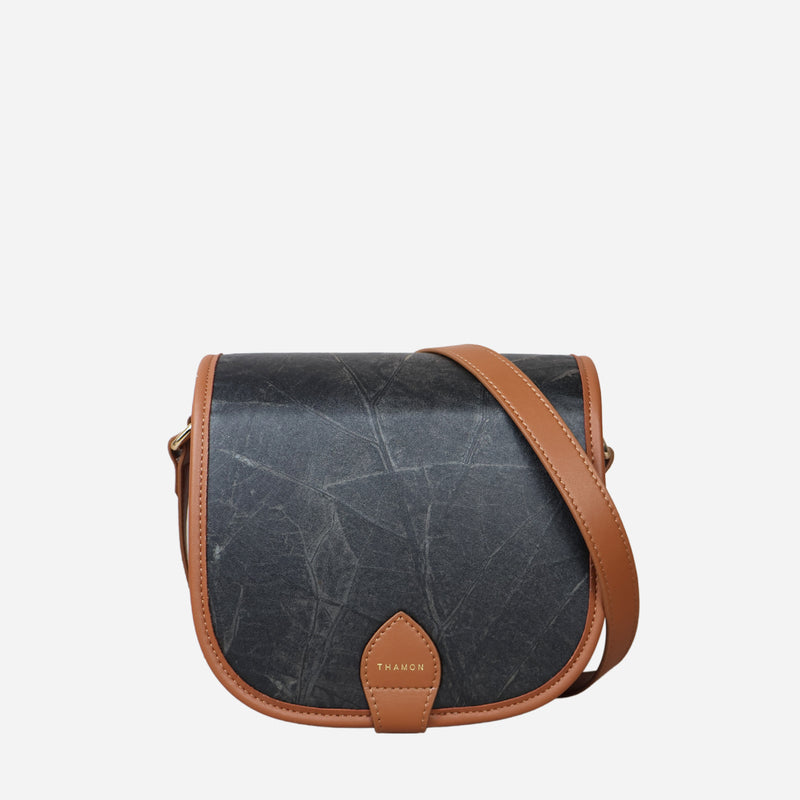 Front view of Heidi Vegan Crossbody Bag in Black by Thamon showcasing its unique leaf pattern and sleek design.