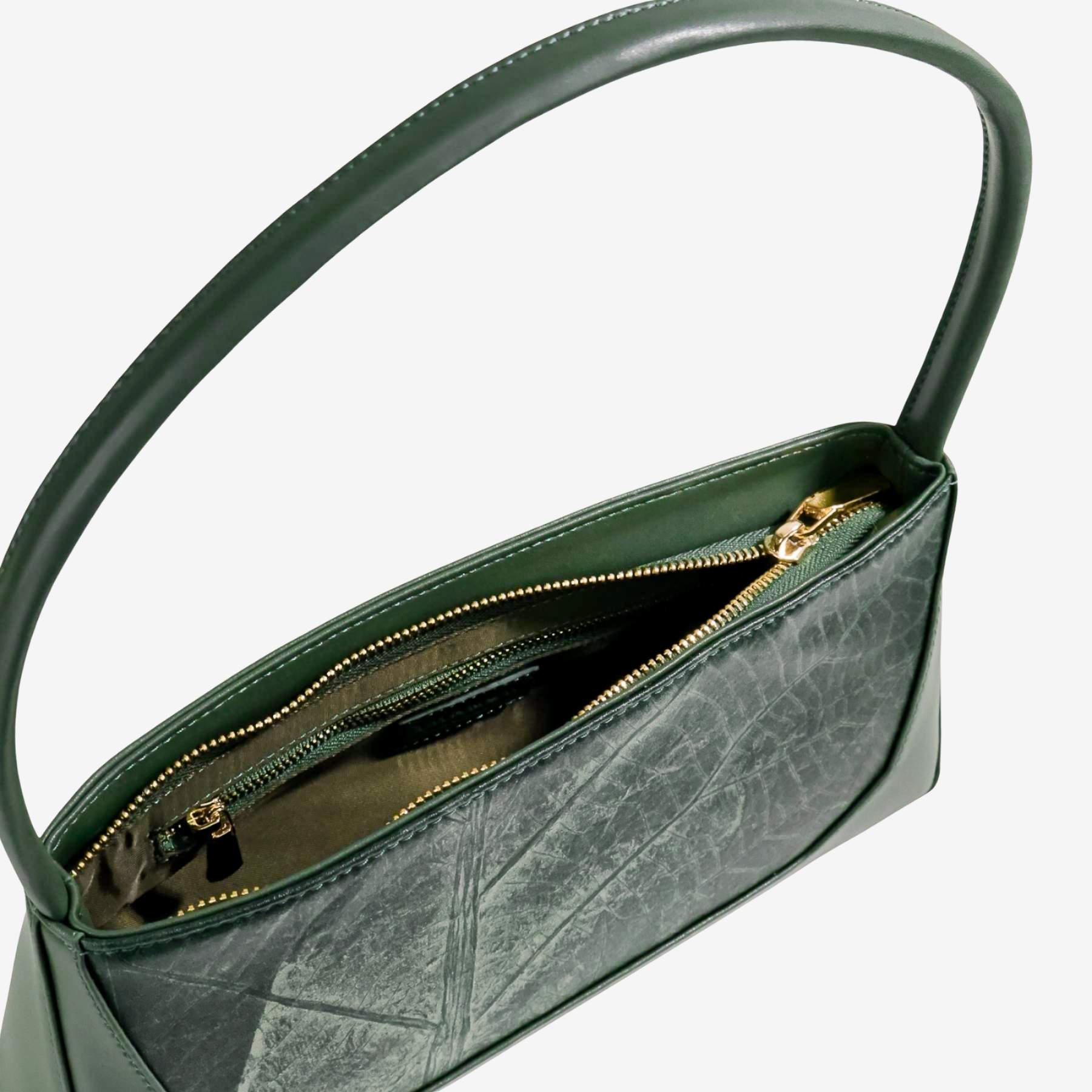 Interior view of forest green IVES bag displaying the spacious main compartment and lining