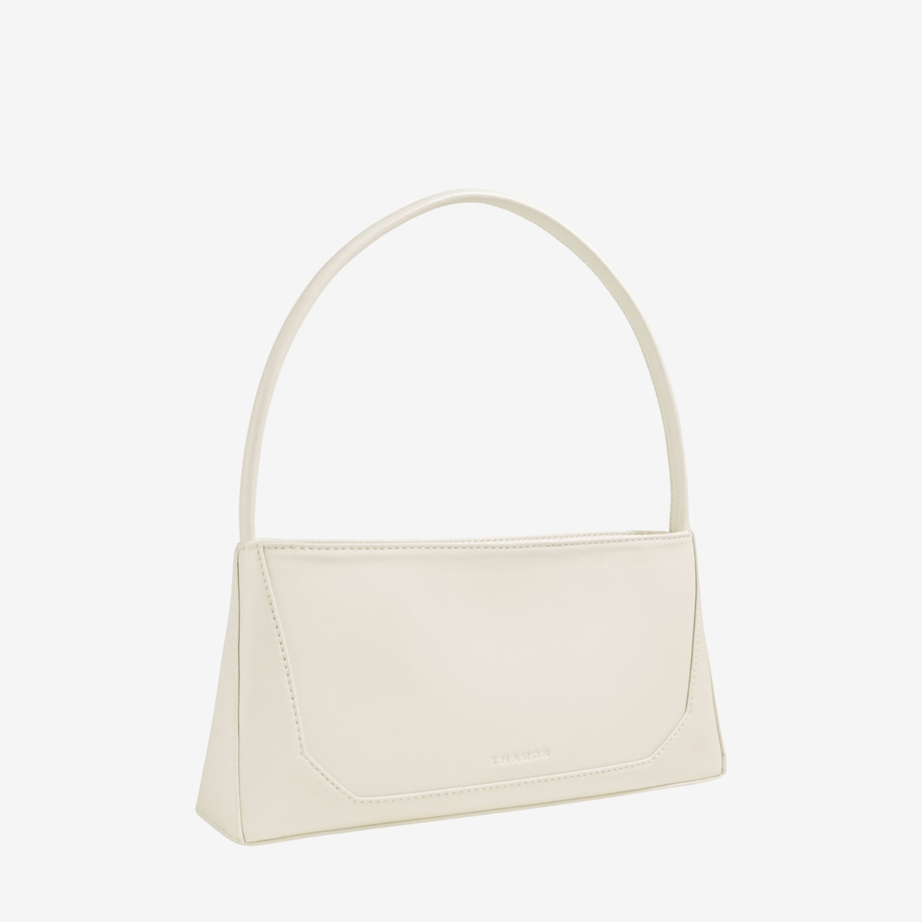 Three-quarter angle of IVES bag in ivory leaf leather highlighting its modern silhouette