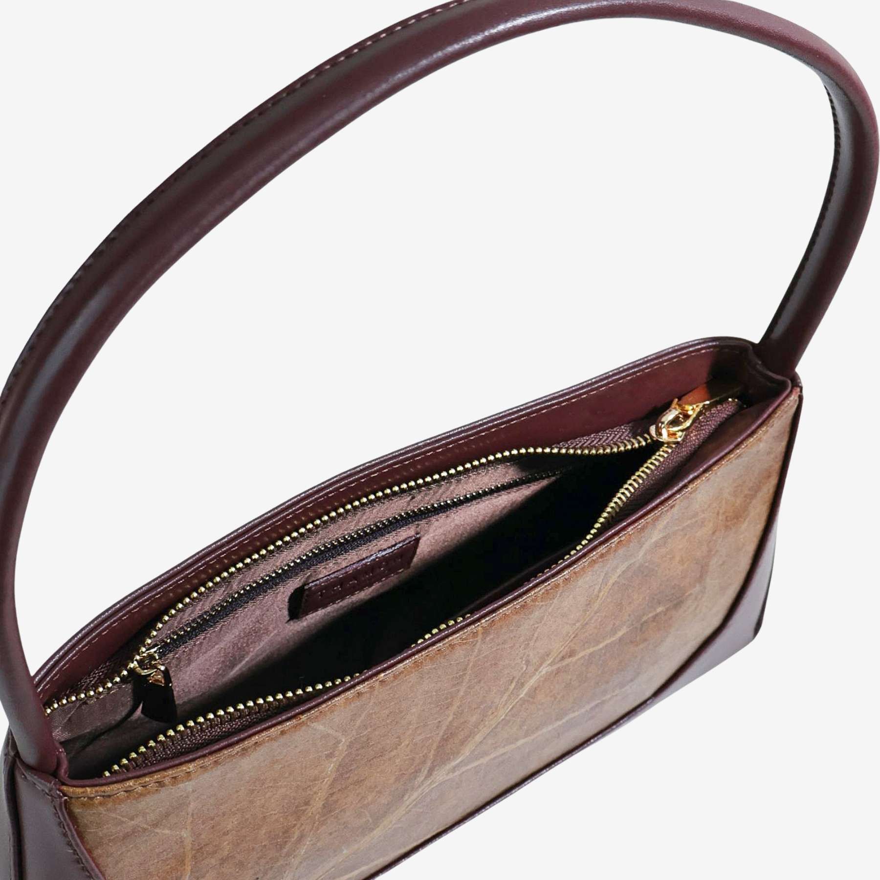 Interior view of spice brown IVES bag featuring premium lining and secure closure system