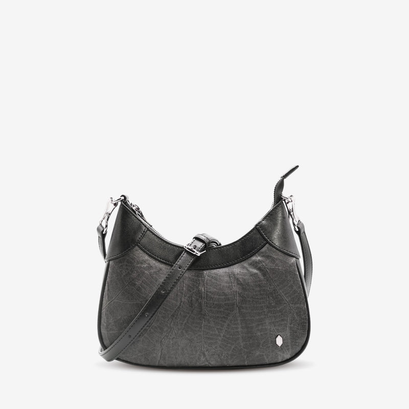 Front view of Kara Vegan Shoulder Bag in Black by Thamon with detachable crossbody strap showcasing its unique leaf pattern and sleek design.