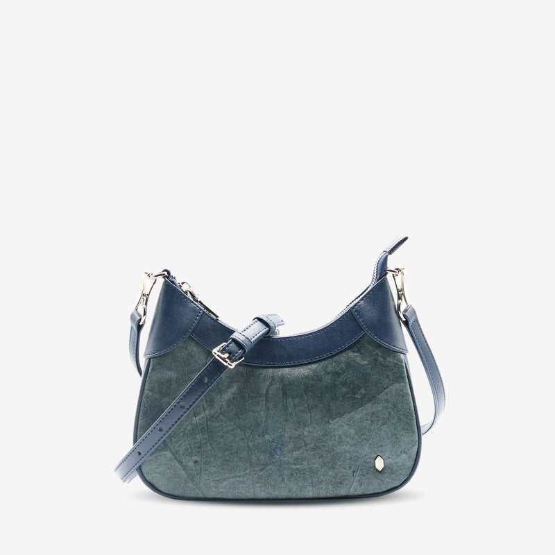 Front view of Kara Vegan Shoulder Bag in Blue Dianne by Thamon with detachable crossbody strap showcasing its unique leaf pattern and sleek design.