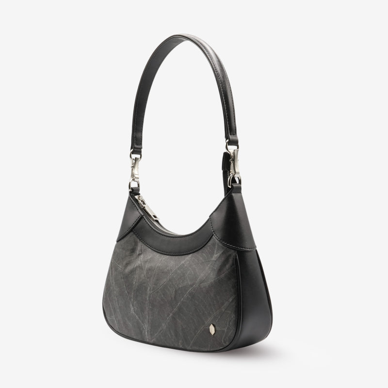 Side view of Kara Vegan Shoulder Bag in Black by Thamon showing the side profile and strap attachment.